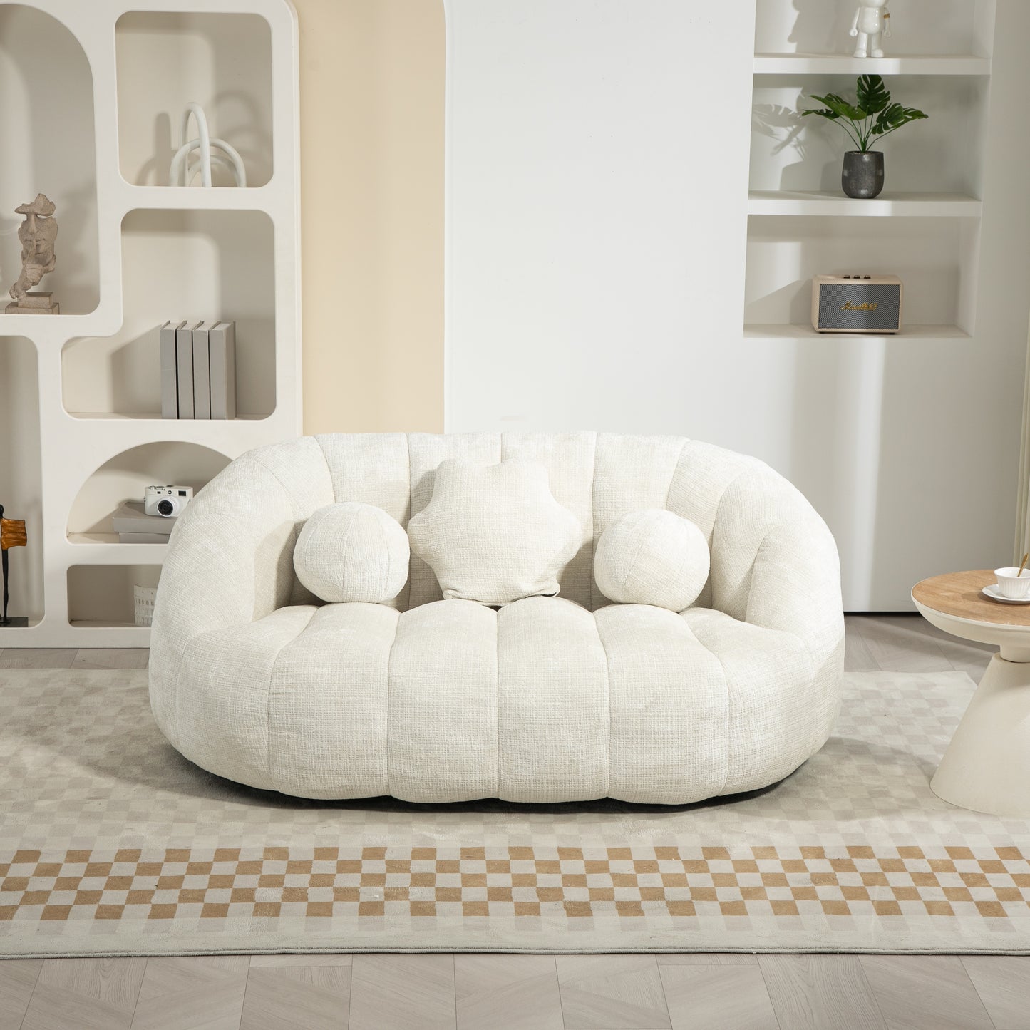 Plush cream boucle sofa with rounded design and decorative pillows perfect for a modern living room