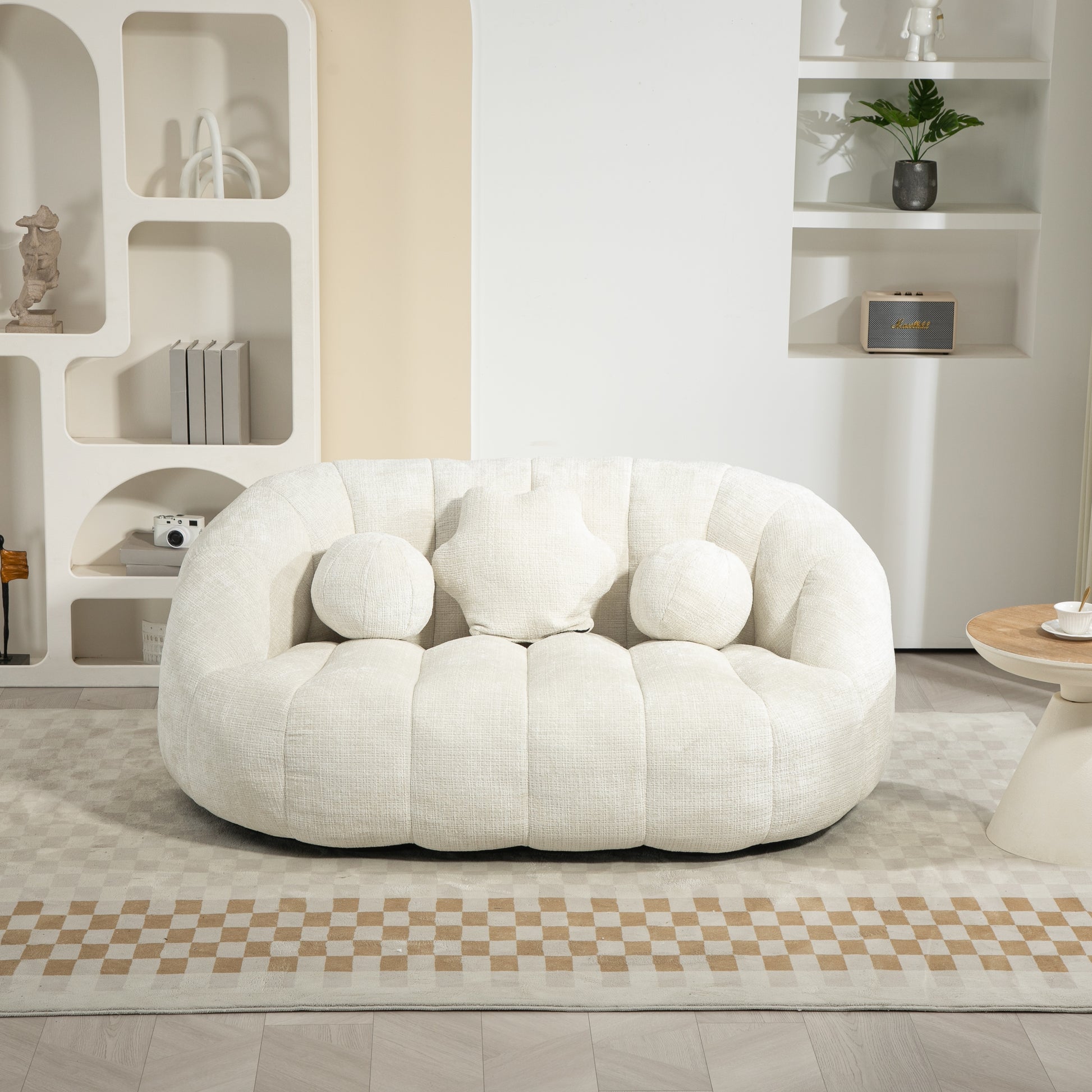 Plush cream boucle sofa with rounded design and decorative pillows perfect for a modern living room
