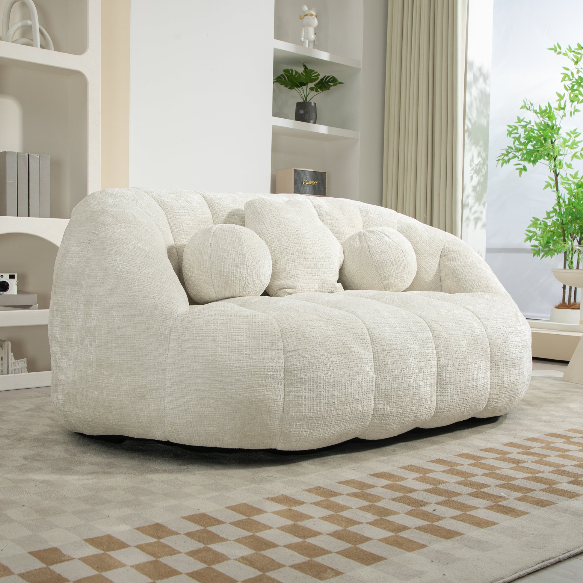 Plush ivory boucle fabric couch with rounded arms and three decorative pillows for a cozy living room