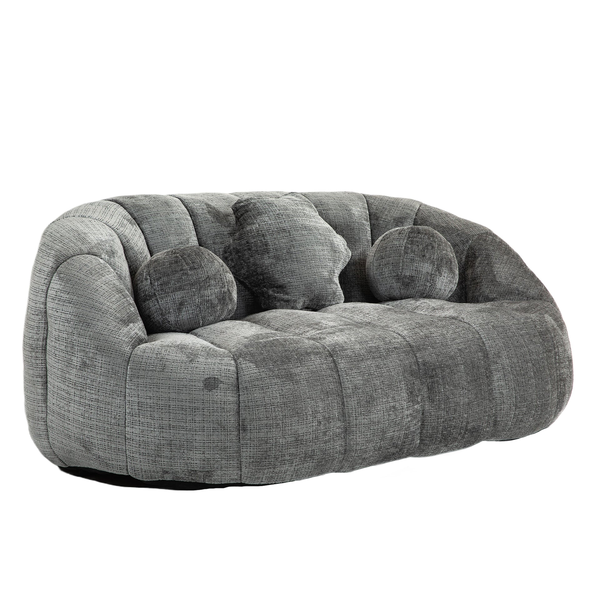 Plush grey velvet sofa with channel tufting and three decorative throw pillows for living room comfort
