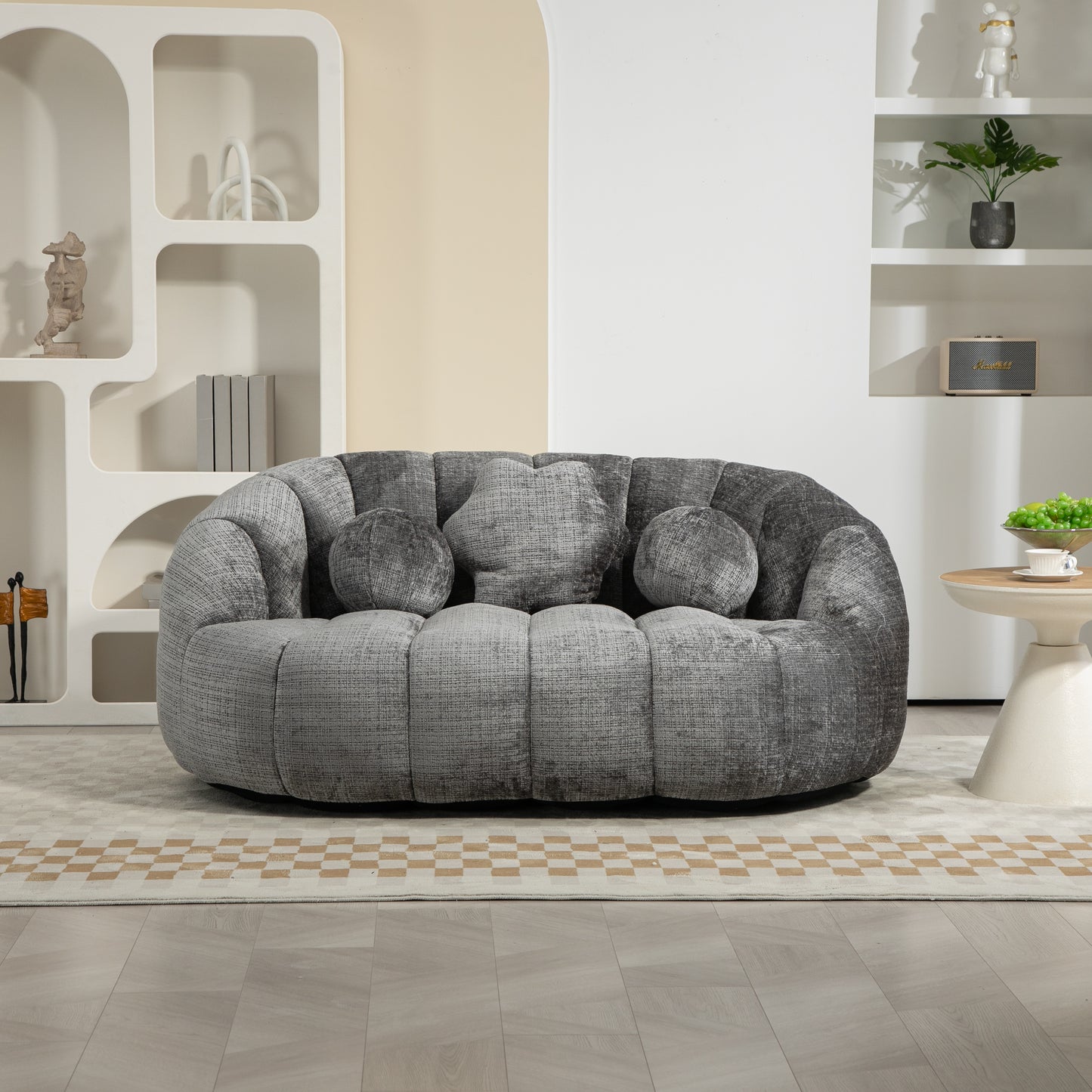 Plush grey upholstered twoseater sofa with curved arms and decorative pillows modern design
