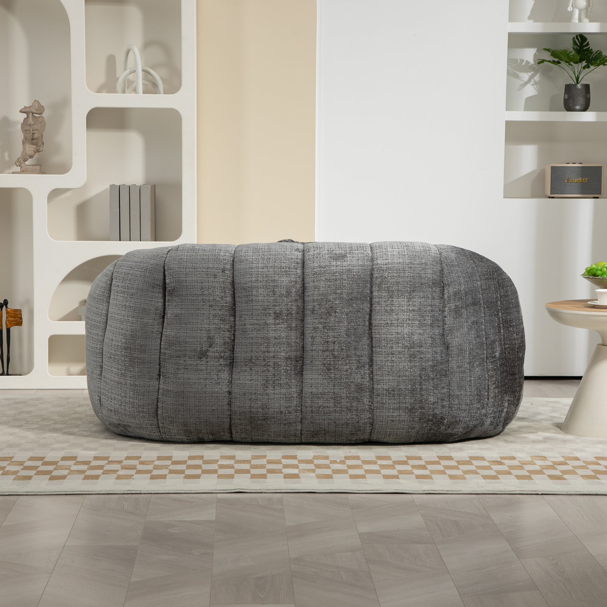 Gray textured fabric ottoman with channel tufting perfect for modern living rooms
