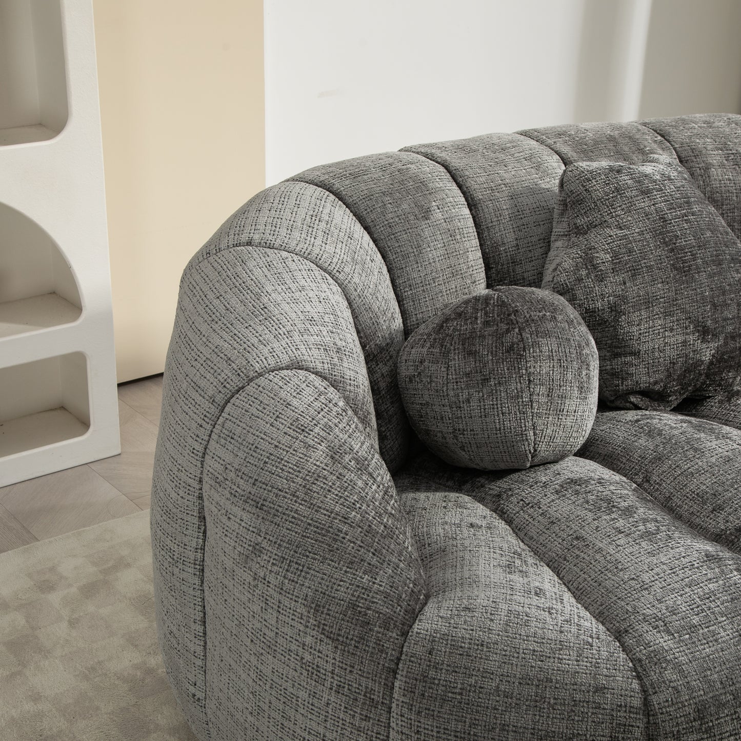 Textured grey velvet sofa with plush cushions modern living room seating
