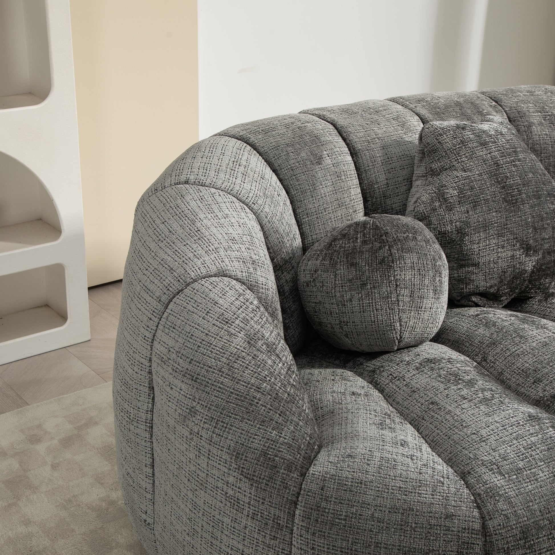 Textured grey velvet sofa with plush cushions modern living room seating