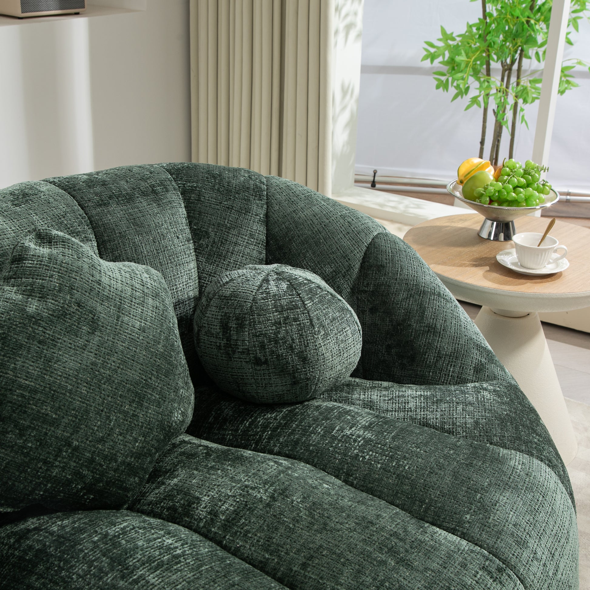 Plush emerald green velvet armchair with channel tufting and accent pillows