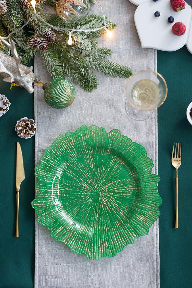 Emerald green glass charger plate with gold sunburst design