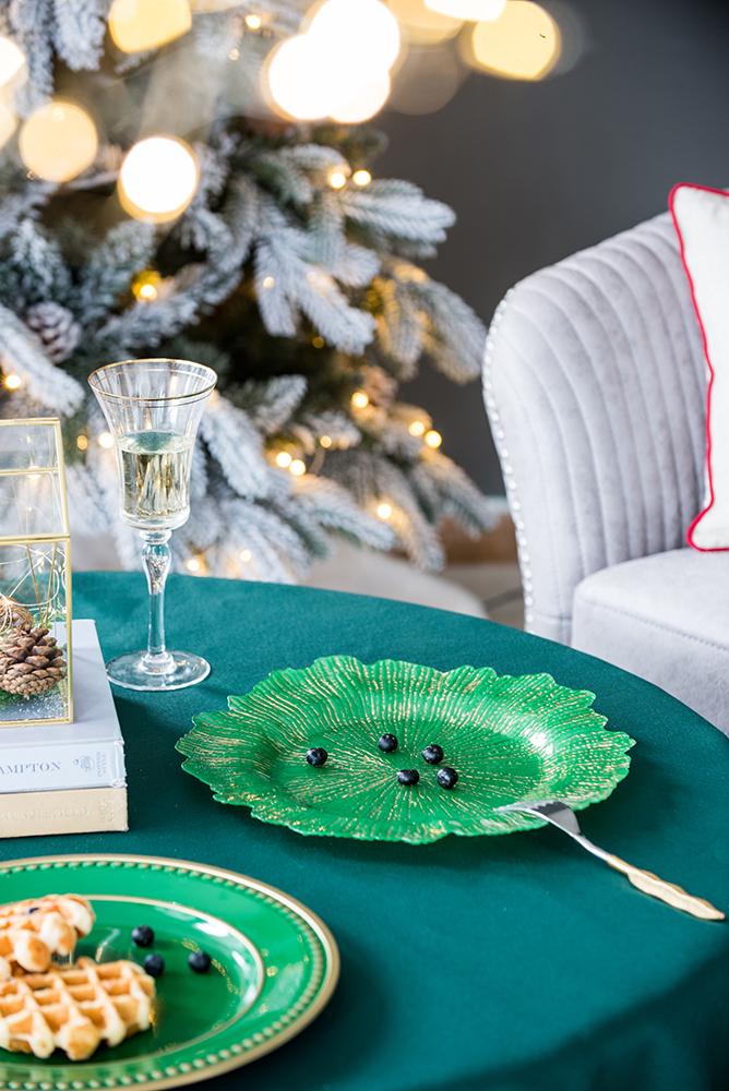 Decorative green glass serving dish with gold trim perfect for holiday gatherings