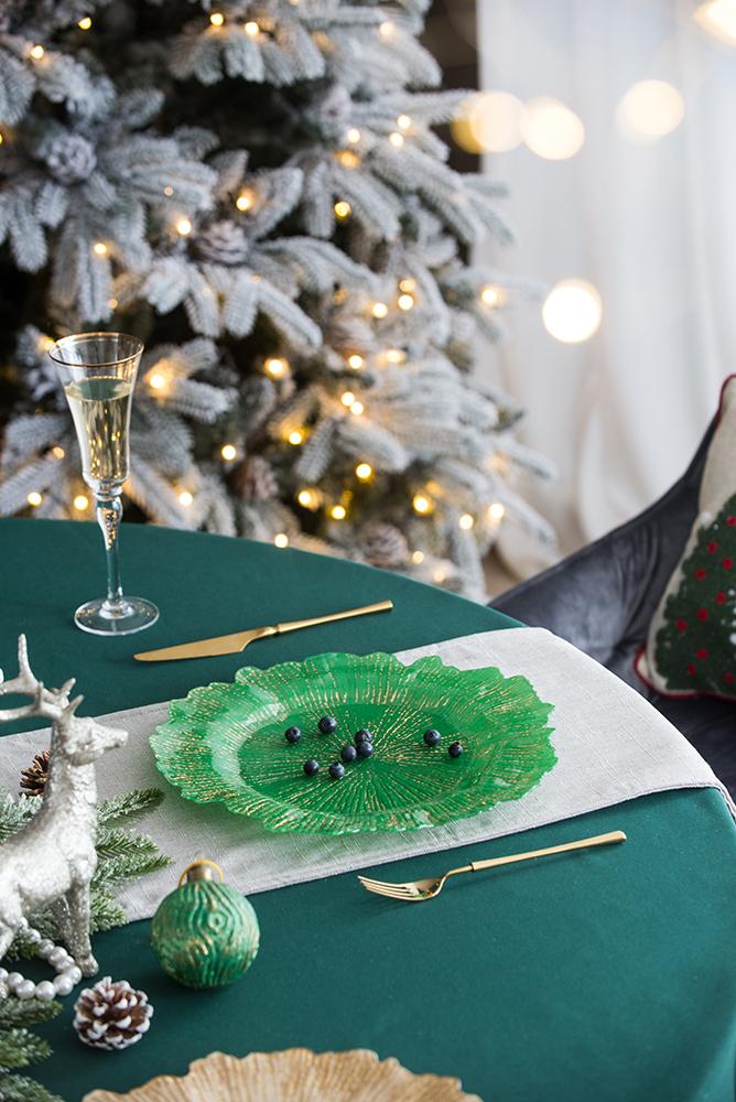 Festive green glass charger plate with gold accents perfect for holiday entertaining
