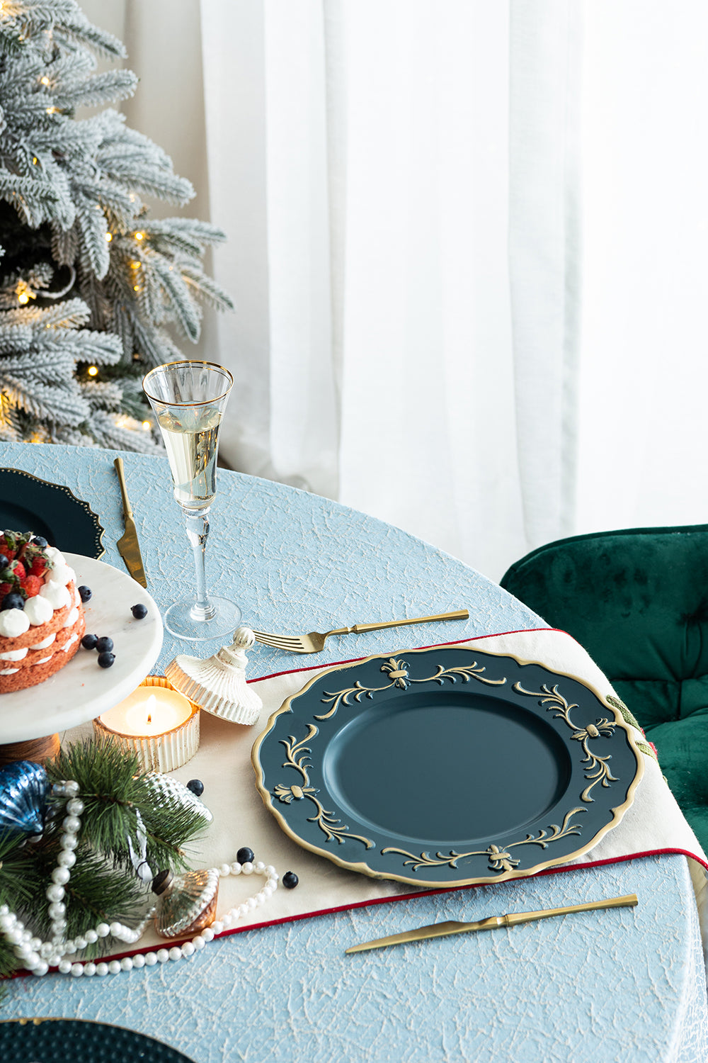 Elegant dark teal charger plate with ornate gold floral embossing for formal dining
