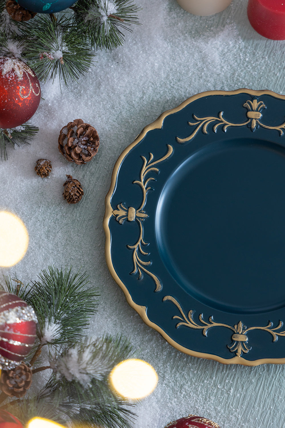 Ornate teal charger plate with gold trim and baroque scrollwork detail