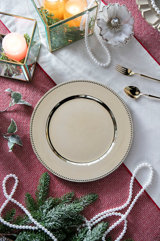 Gold rimmed ivory charger plate with beaded edge for elegant dining