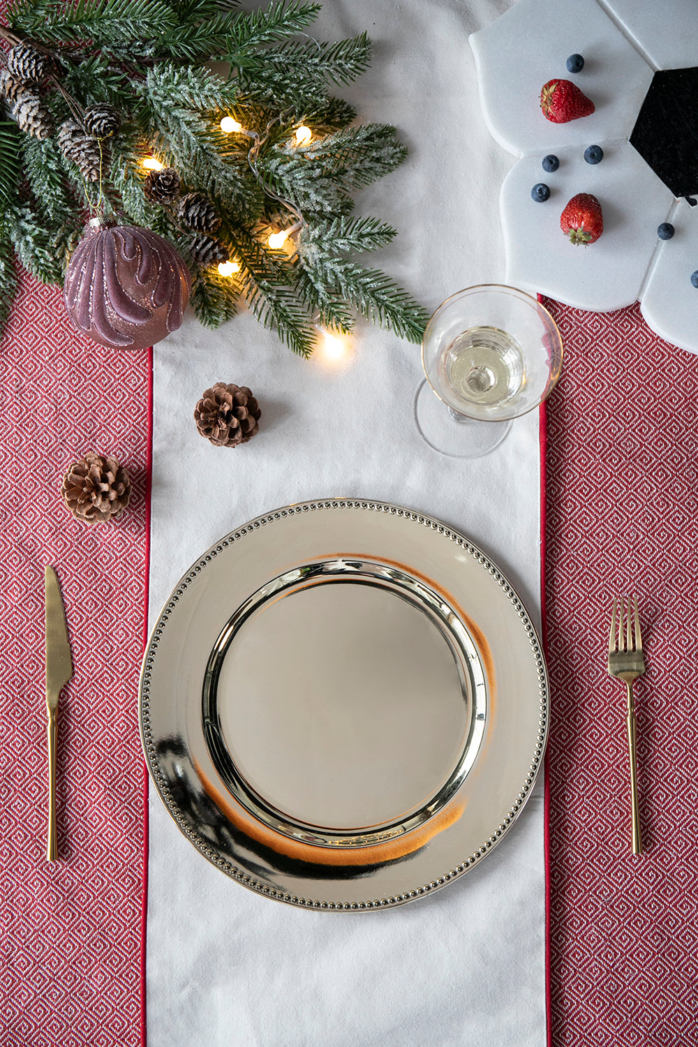 Silver beaded charger plate with festive holiday pine and ornament