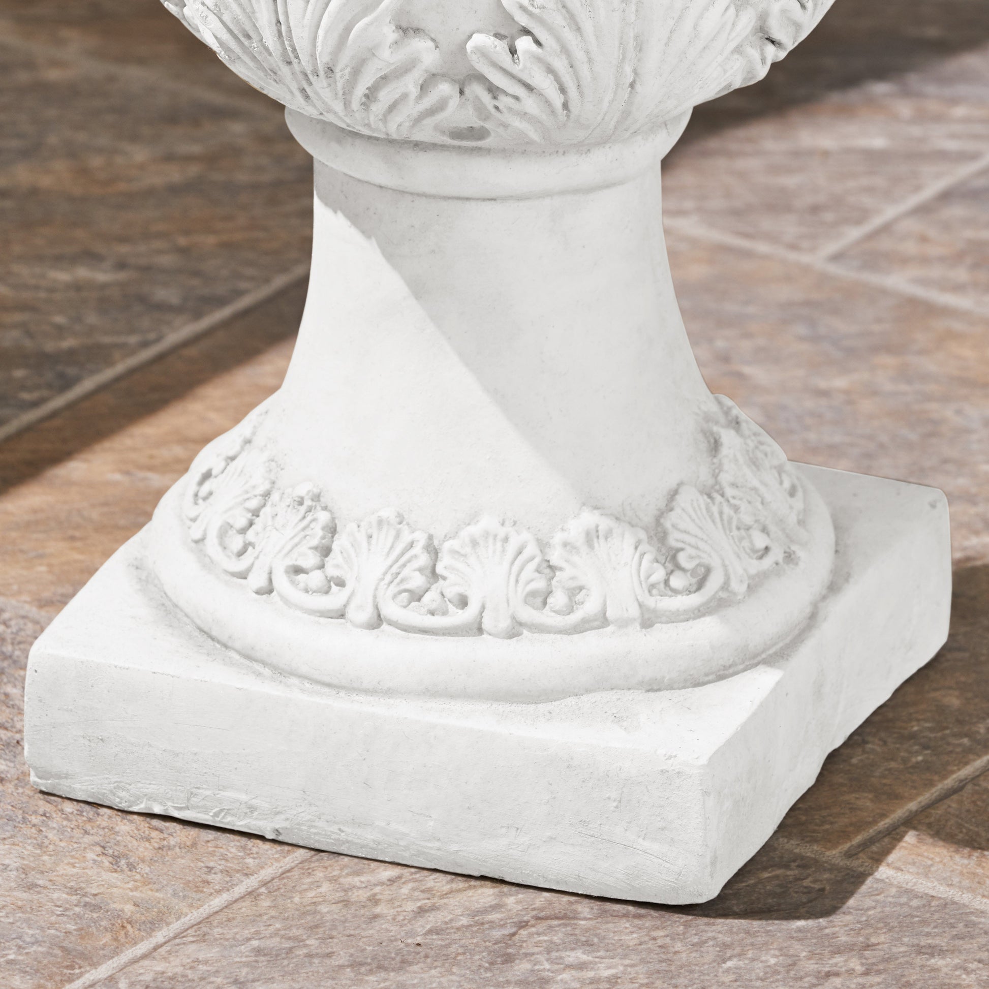 White marble pedestal base with ornate classical leaf motif for garden statue