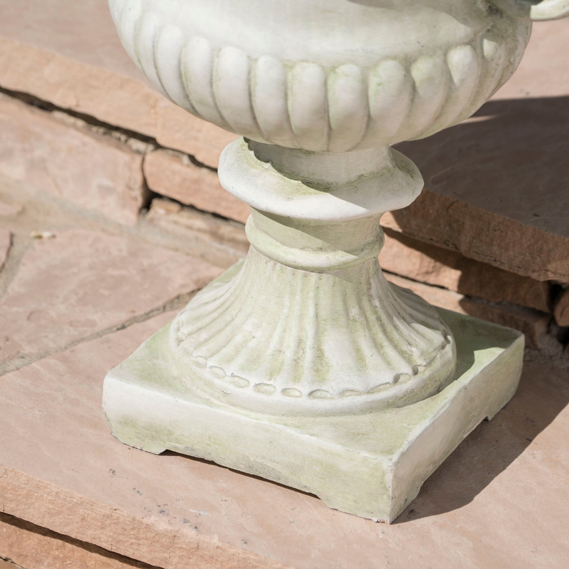 Light green weathered concrete urn classic design suitable for garden decor