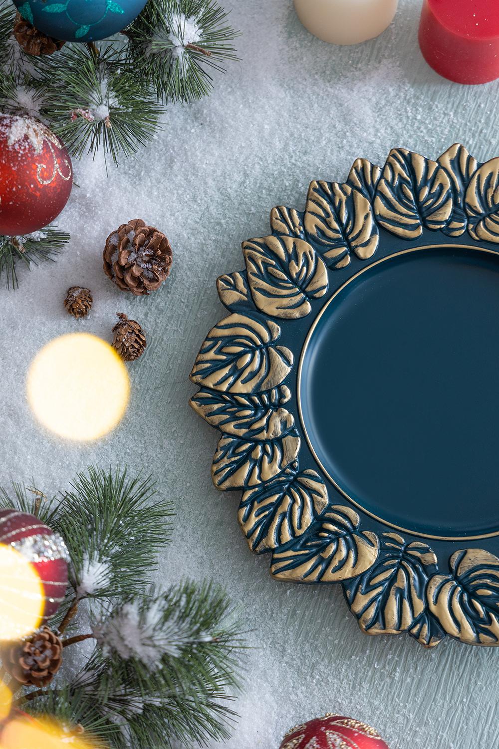 Deep teal charger plate with ornate gold leaf embossed rim perfect for holiday table settings