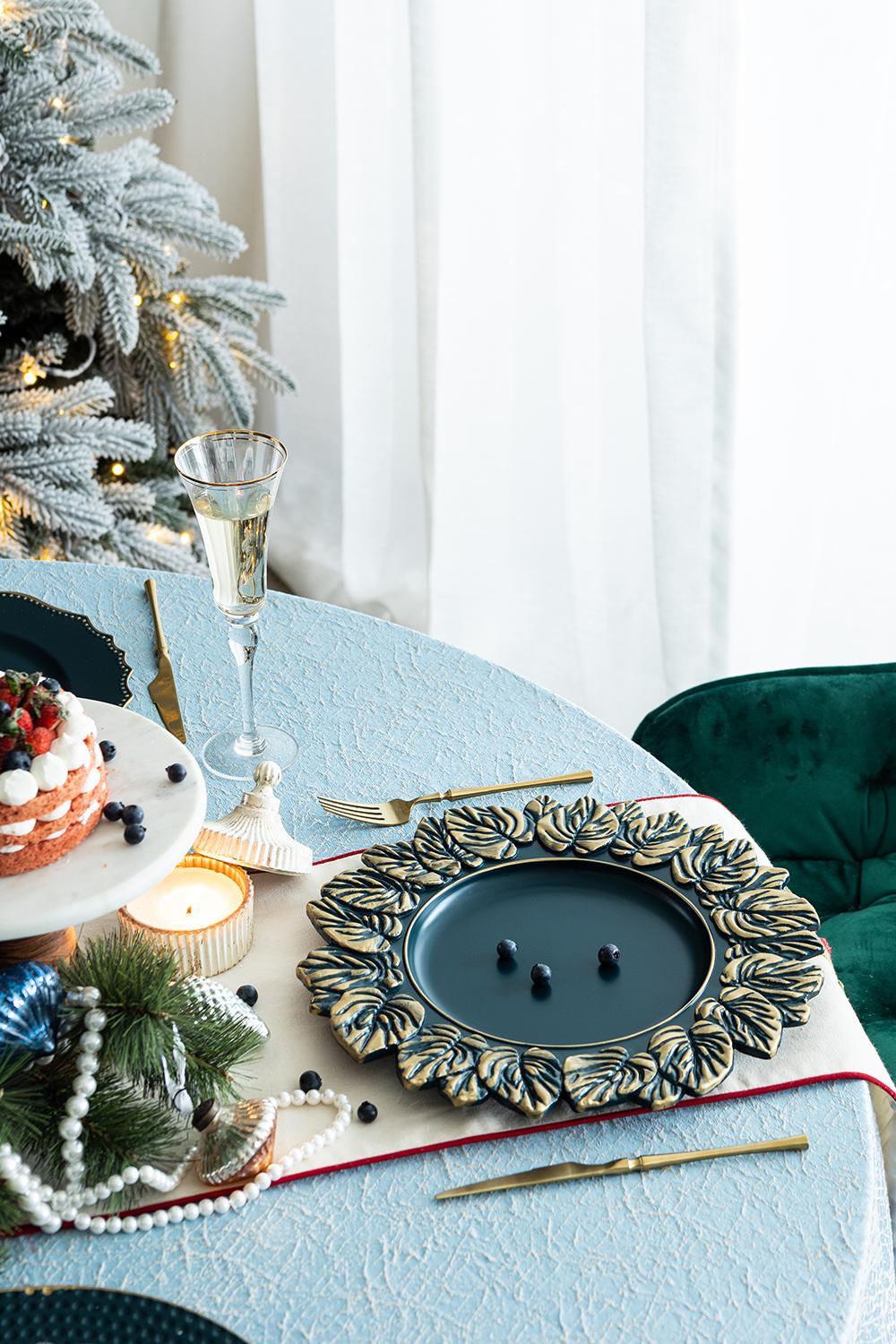 Dark blue charger plate with ornate gold leaf border perfect for festive dining