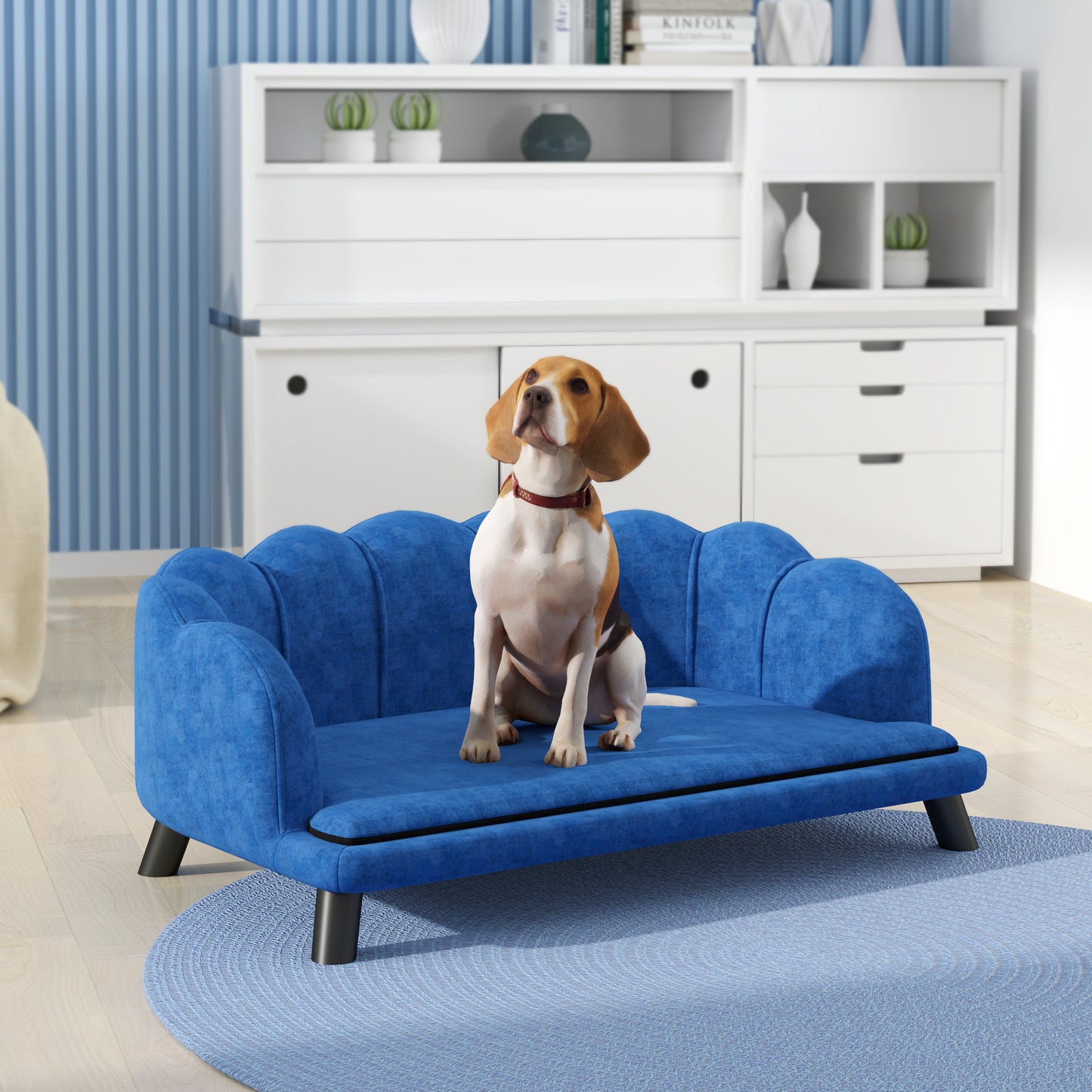 Blue velvet dog couch with scalloped edges and sturdy black legs