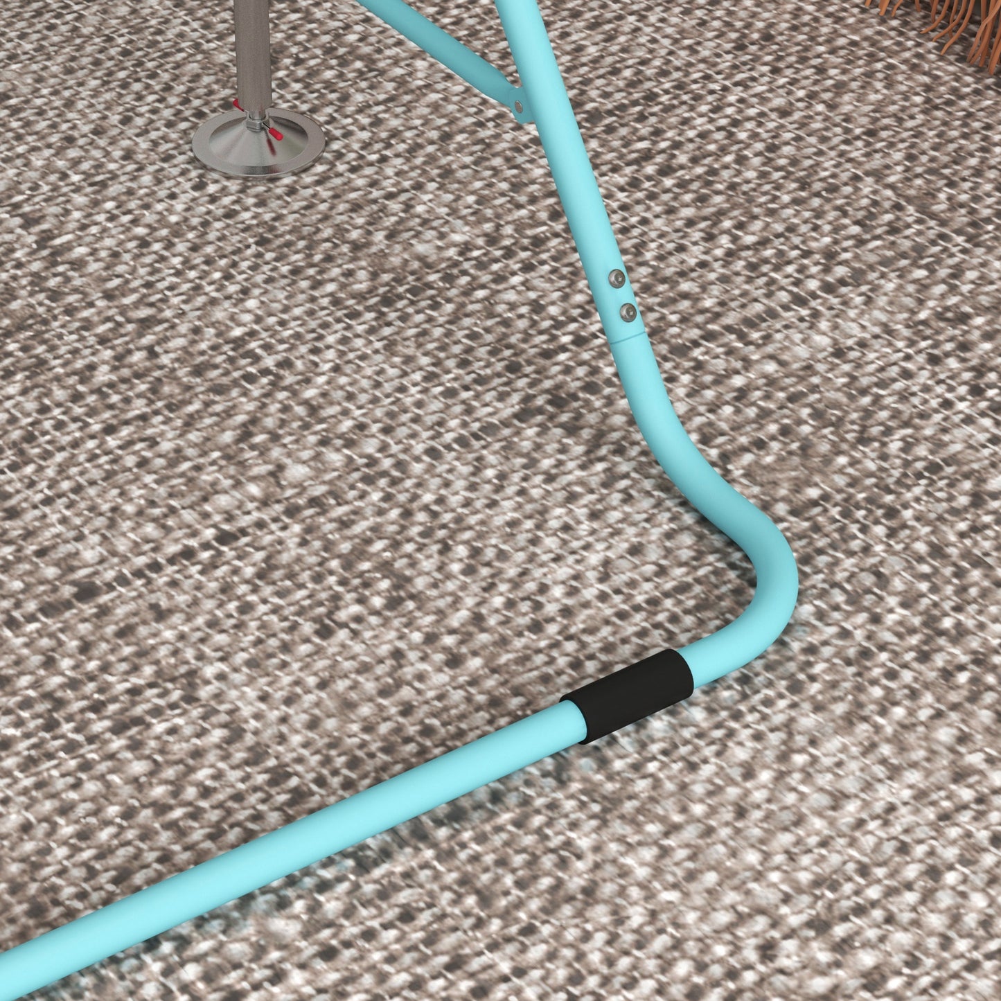 Closeup of a blue metal chair leg with black grip on textured carpet