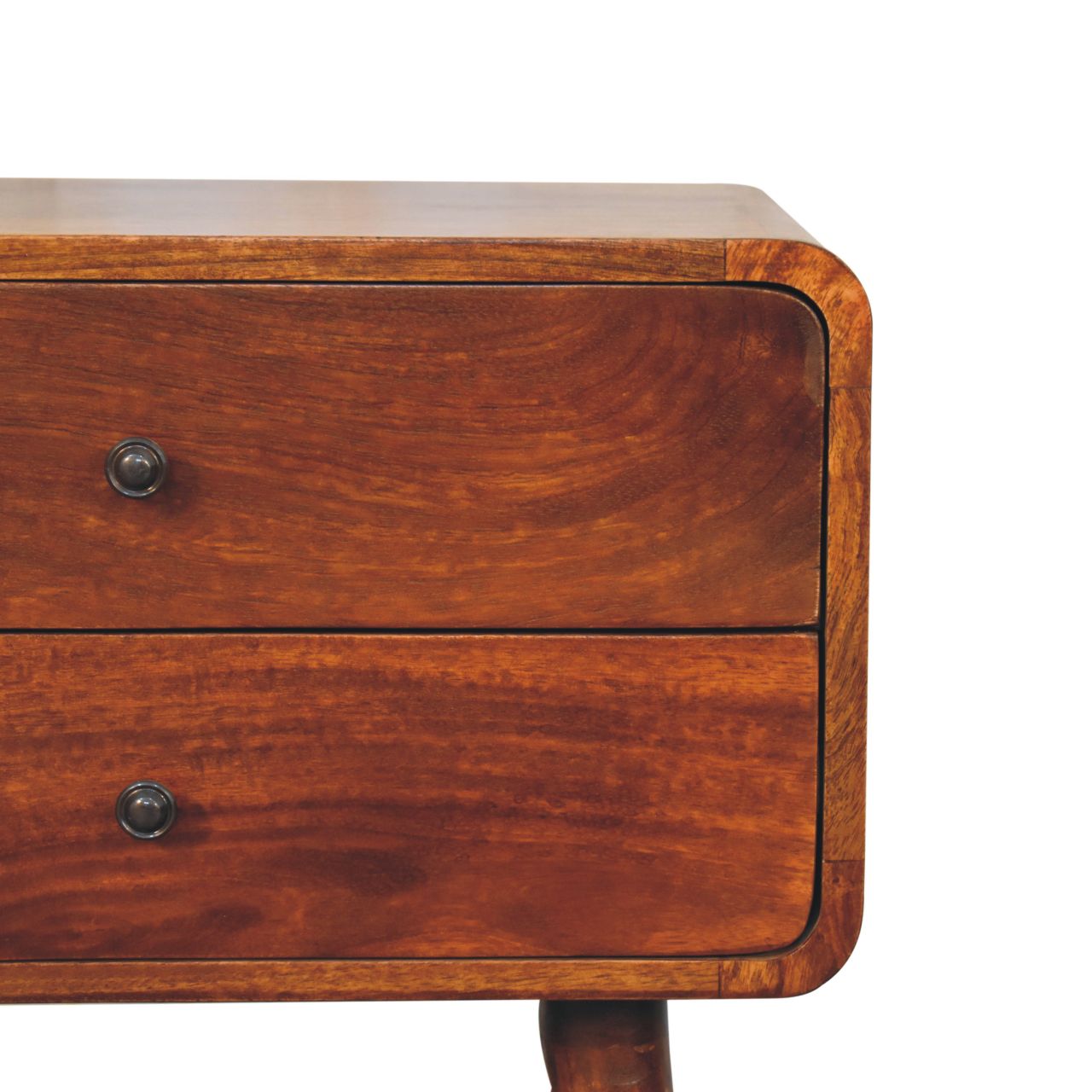 Closeup of a rounded midcentury modern bedside table with two walnut drawers and dark metal knobs