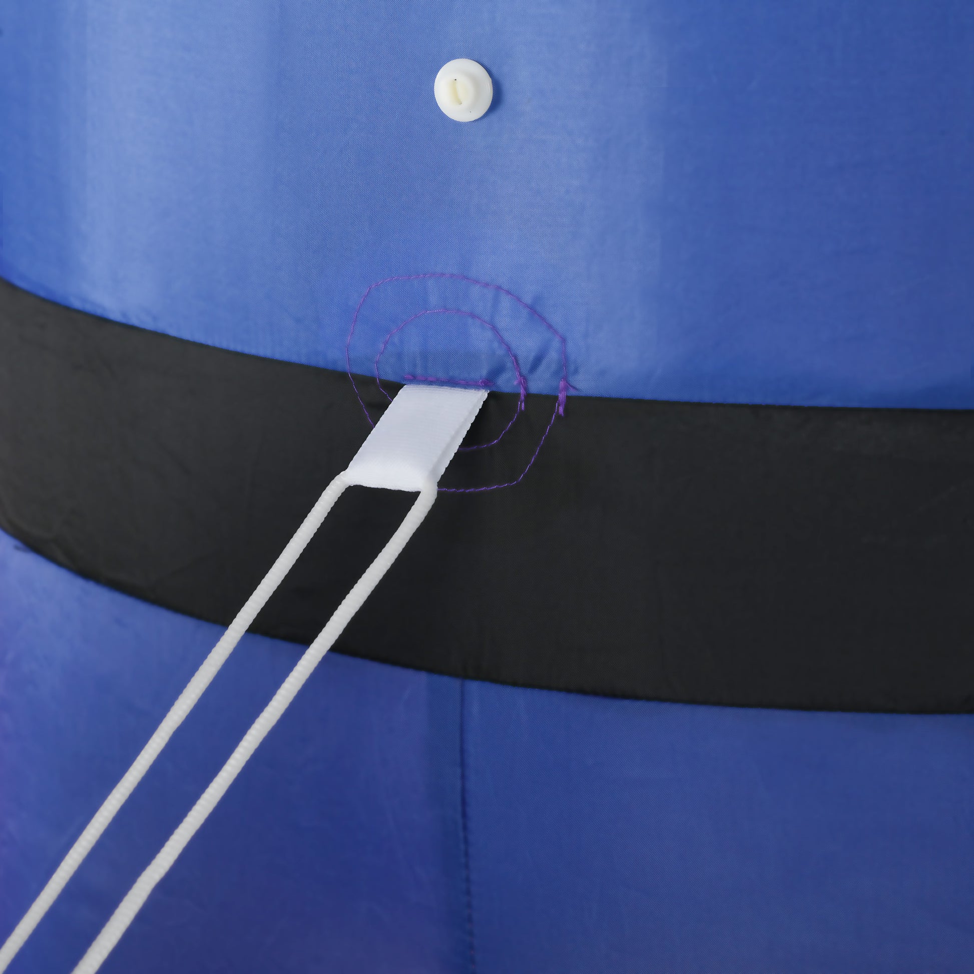 Closeup of blue inflatable fabric with black belt and white tiedown strap
