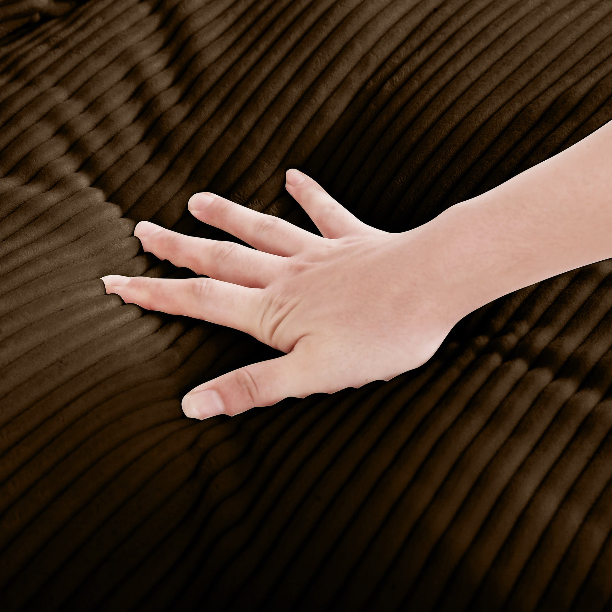 Hand touching luxurious dark brown corduroy fabric texture with soft nap
