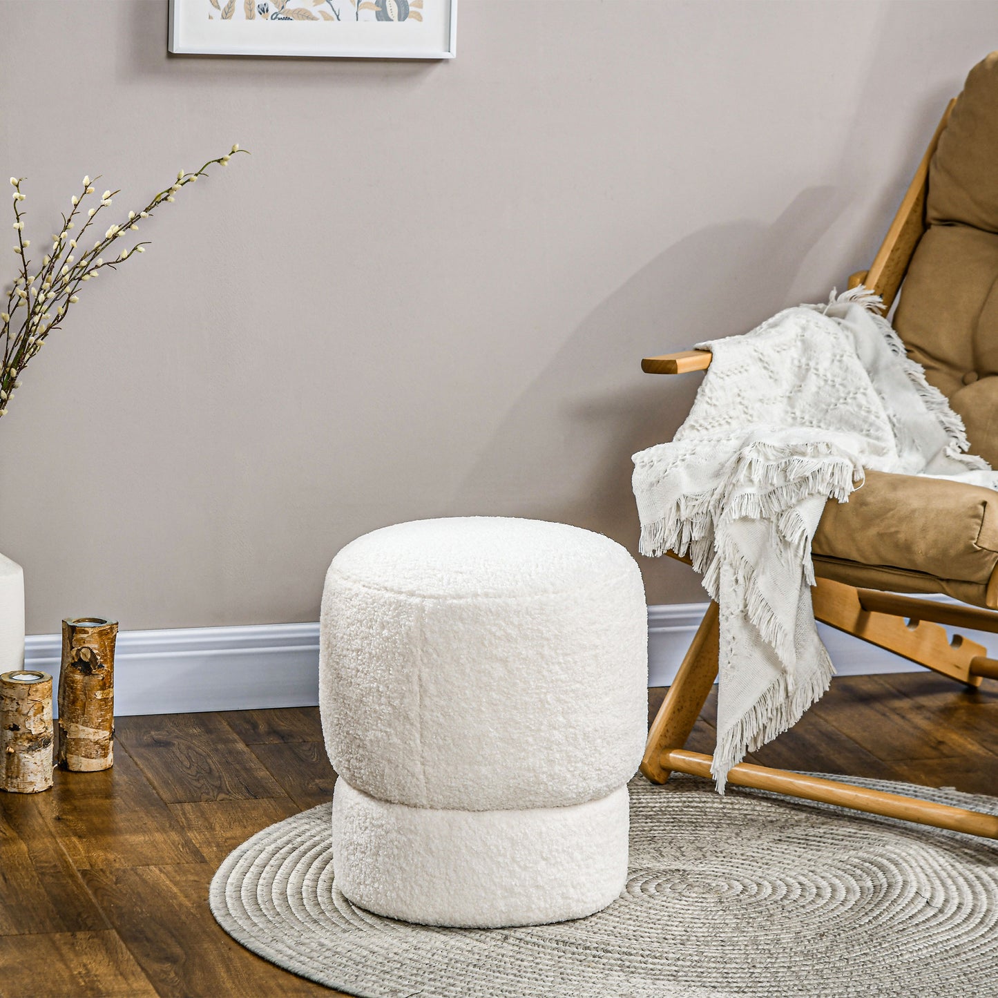 Plush white boucl ottoman with a rounded shape perfect for living rooms