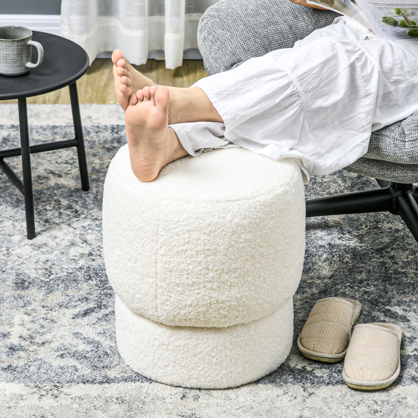 Plush white round ottoman perfect for footrest or extra seating in a modern living room