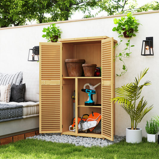 Wooden garden storage cabinet with louvered doors holding terracotta pots watering can and power tools