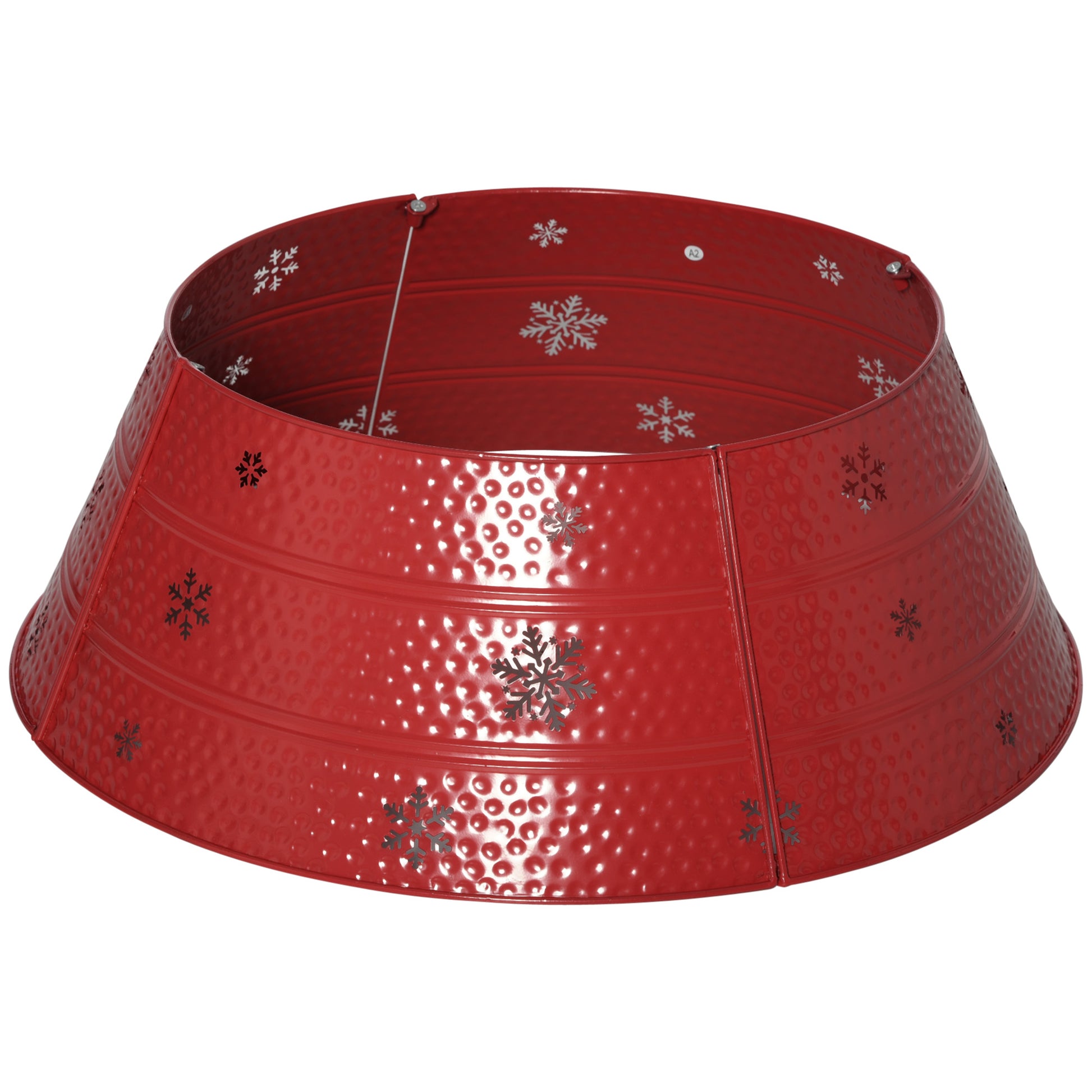 Red metal christmas tree skirt with embossed dots and snowflake cutouts