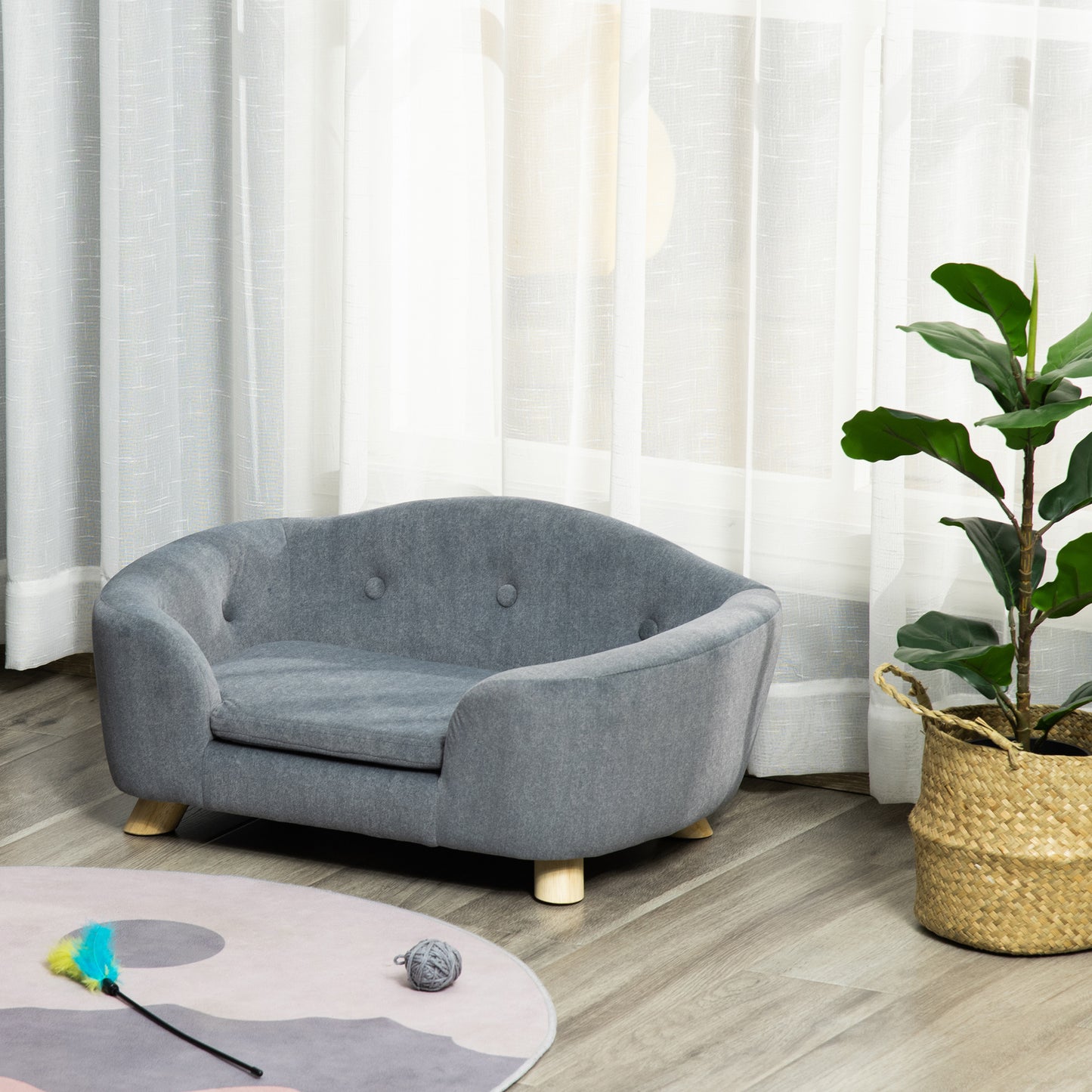 Gray upholstered pet sofa with button tufting and wooden legs