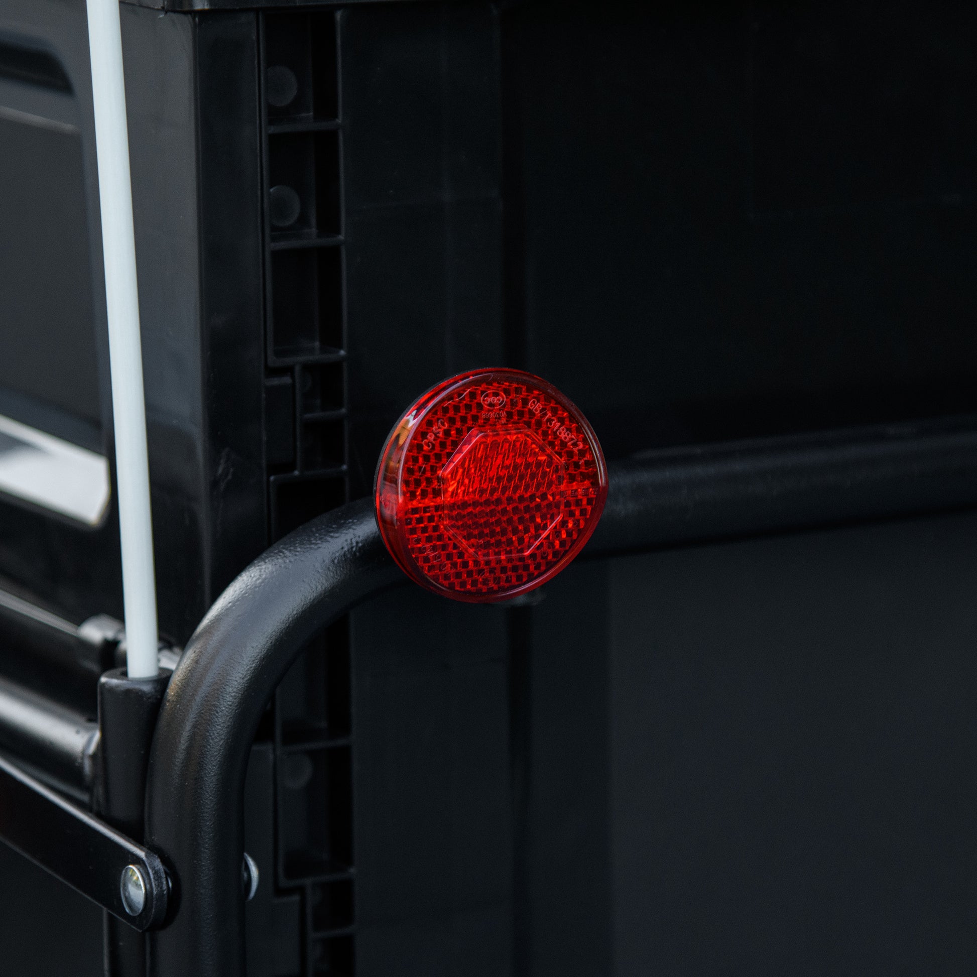 Round red bicycle reflector with hexagonal pattern and certifications