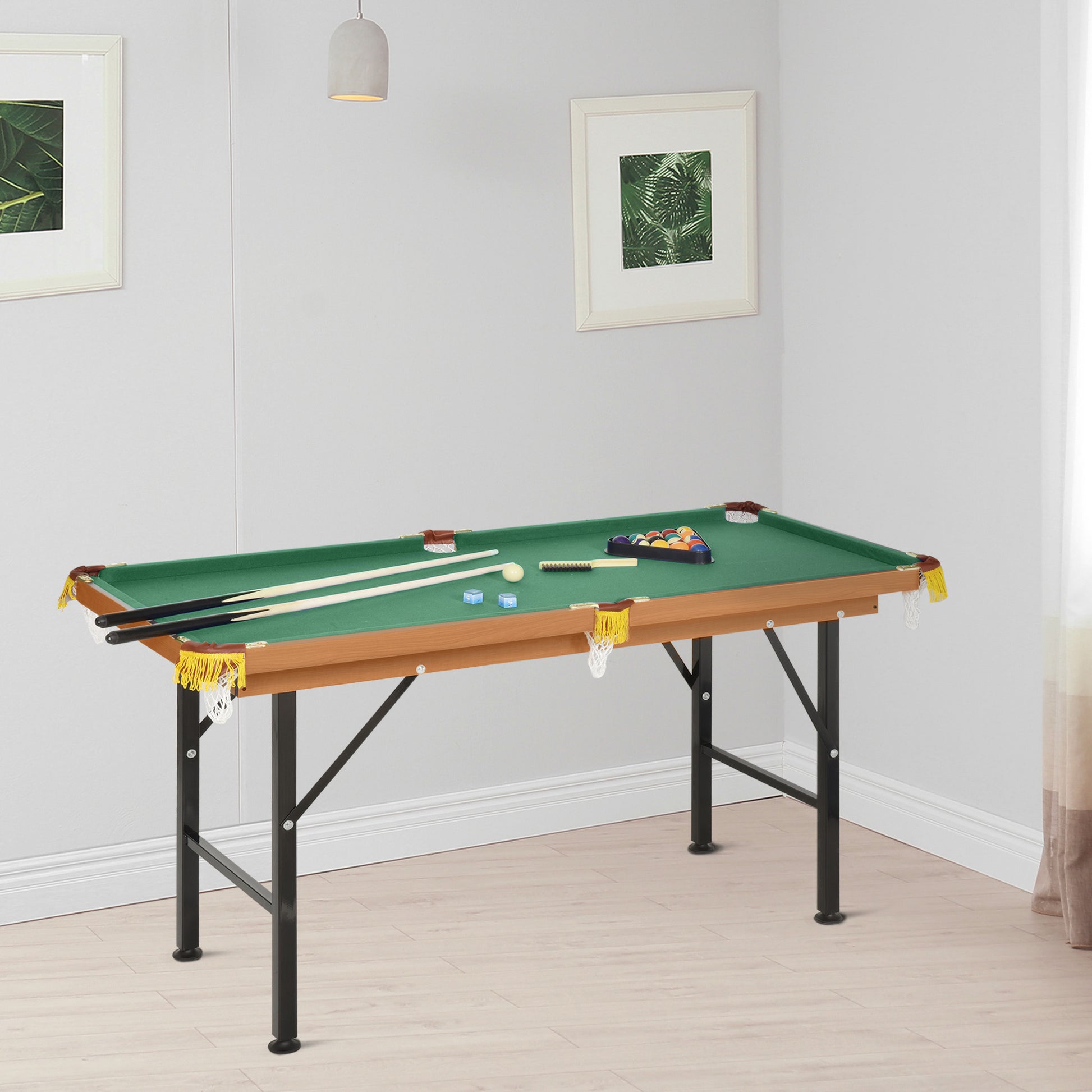 Compact green felt pool table with wood finish and metal legs for easy storage