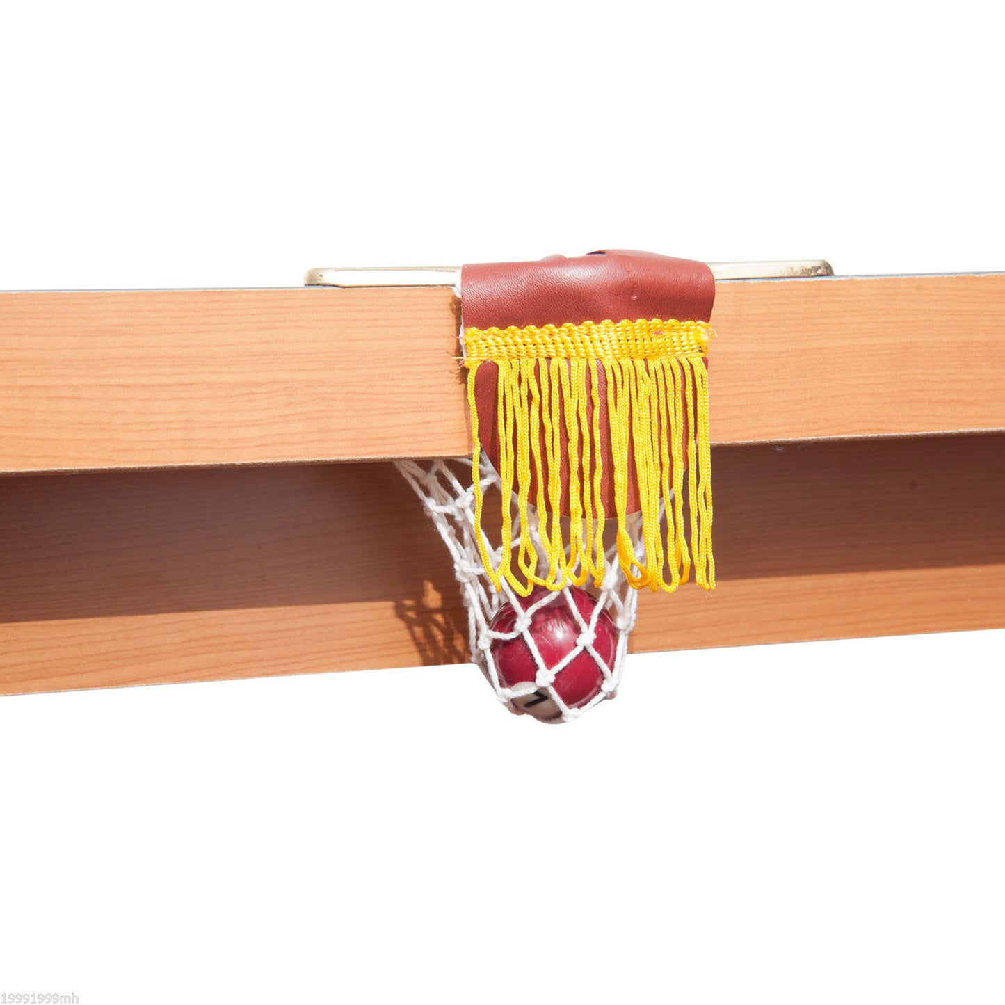 Red billiard ball with number  resting in a white net pocket with yellow fringe on a wooden table
