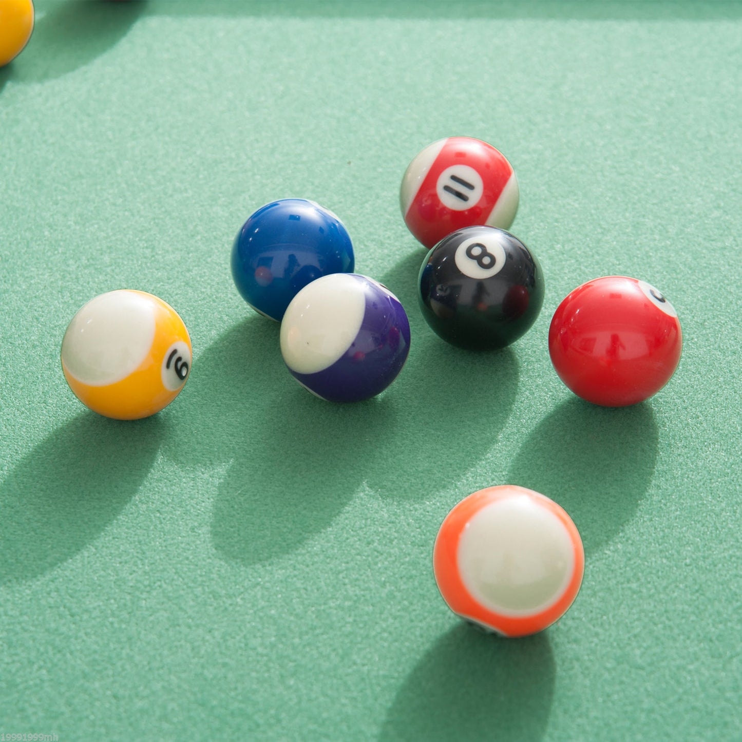 Red and white striped pool ball with number  on a green felt table