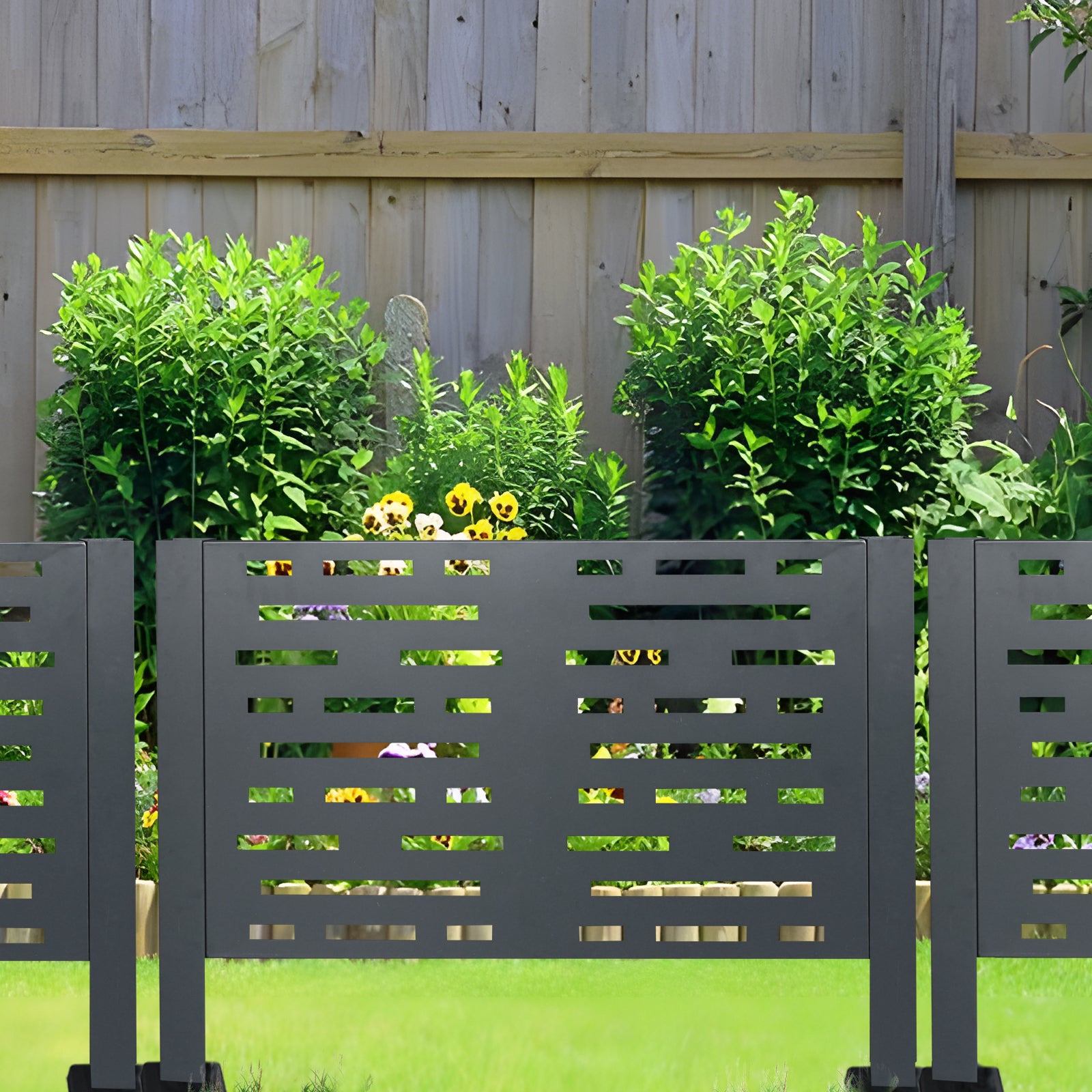 Dark gray modern garden screen with abstract cutouts enhancing outdoor privacy