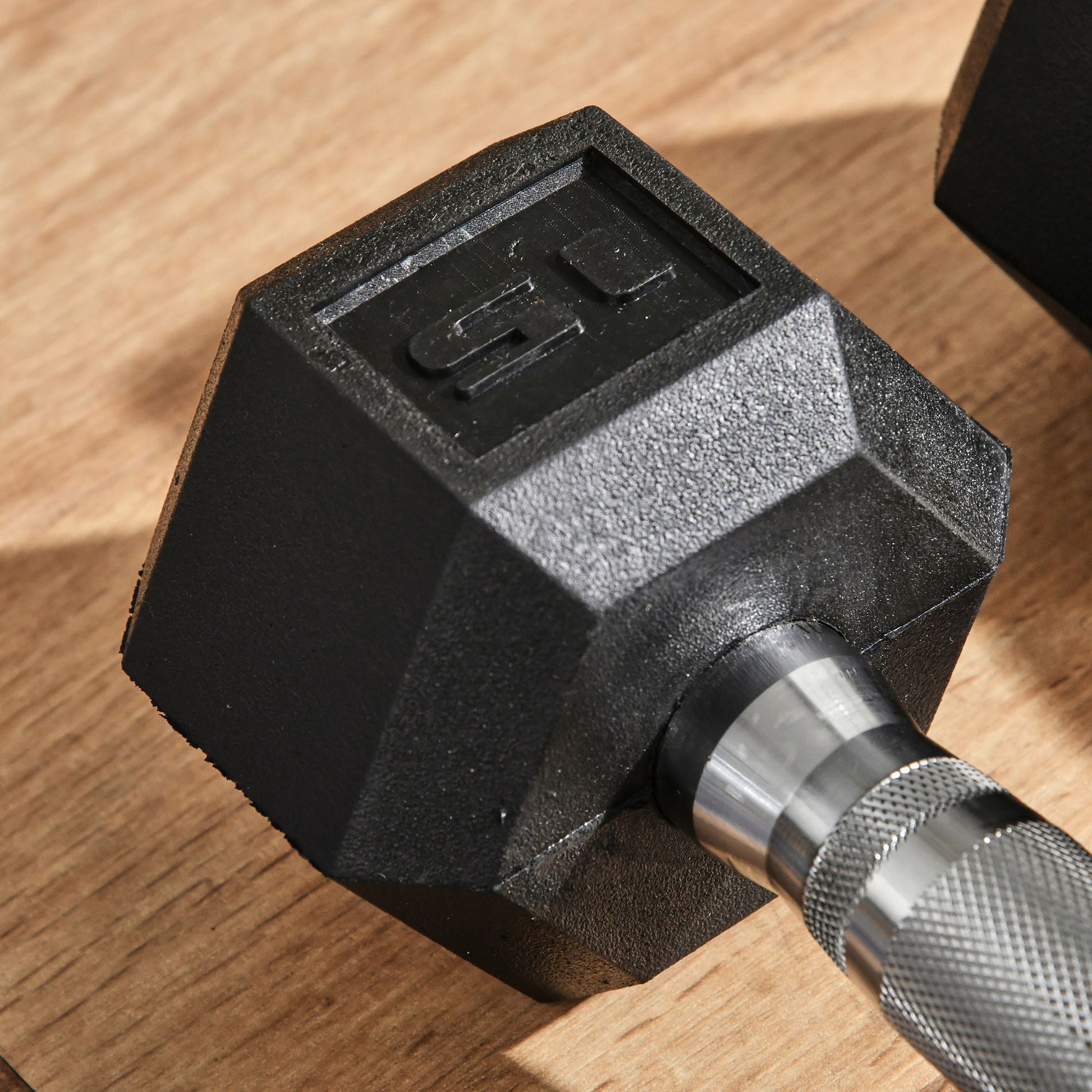 Black hex dumbbell with  lb weight marking textured grip and chrome handle