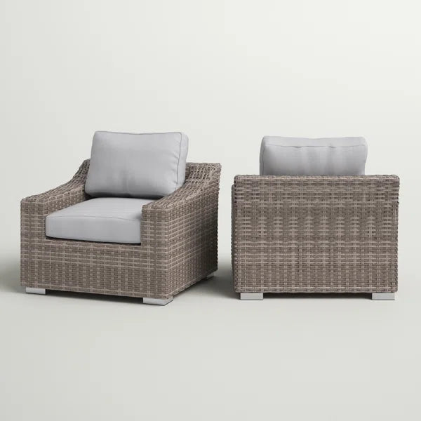 Woven wicker armchair with light gray cushions and silver metal feet perfect for outdoor patios