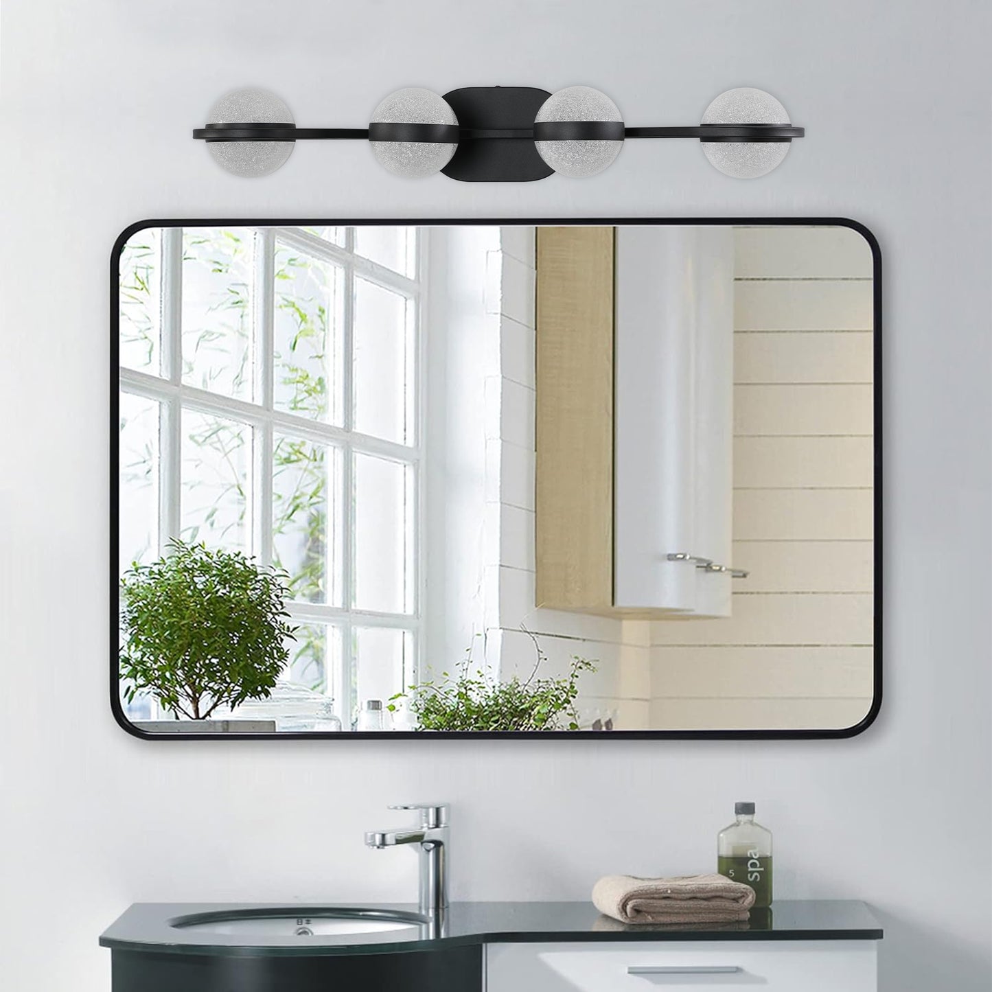 Modern black vanity light with frosted glass globe shades and a sleek design