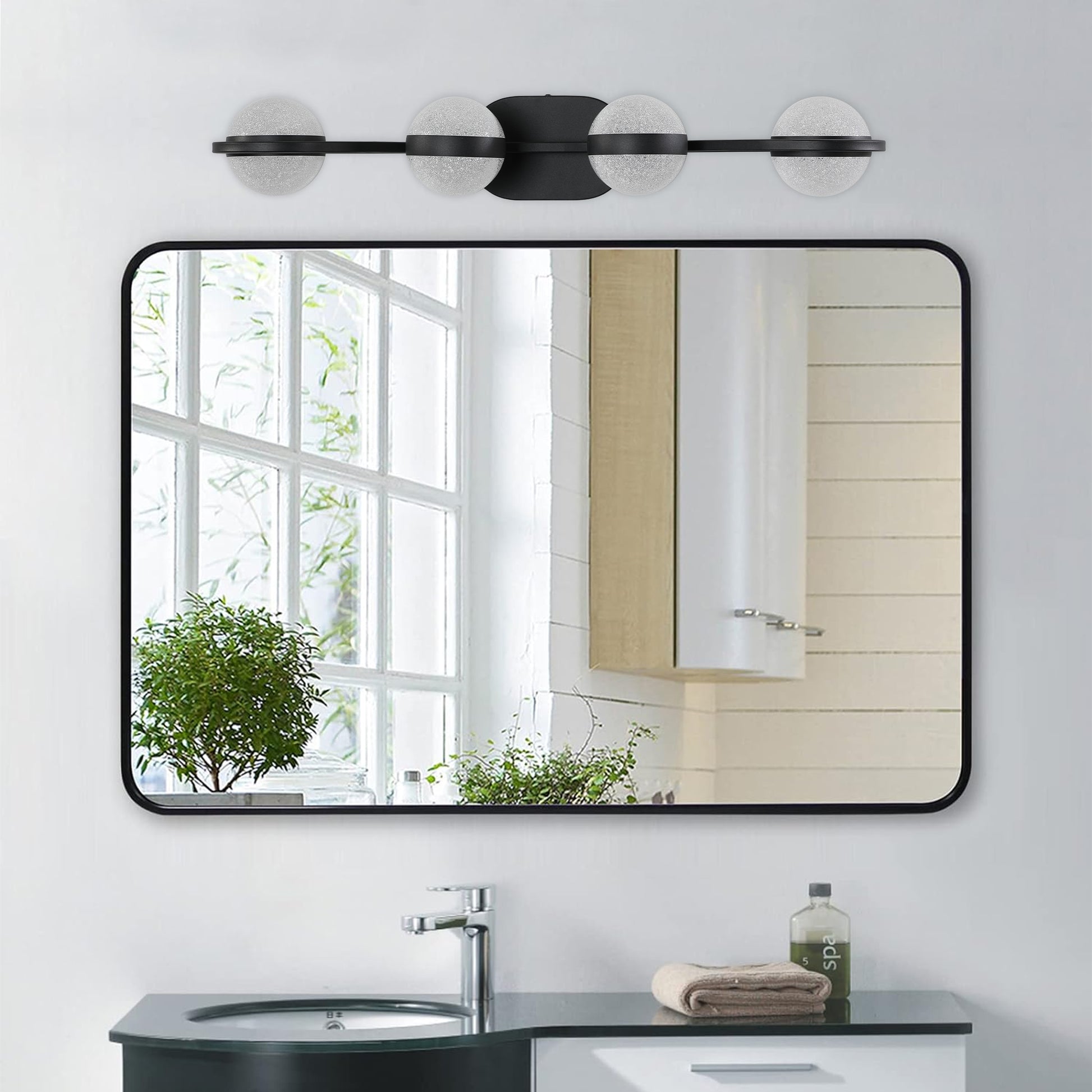 Modern black vanity light with frosted glass globe shades and a sleek design