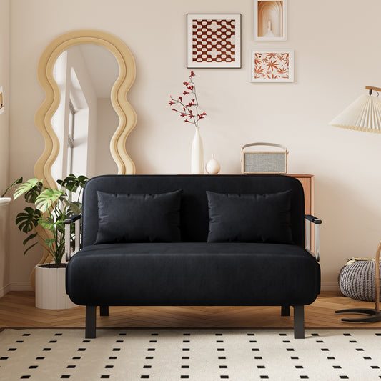 Black upholstered sofa with two dark throw pillows and chrome armrests