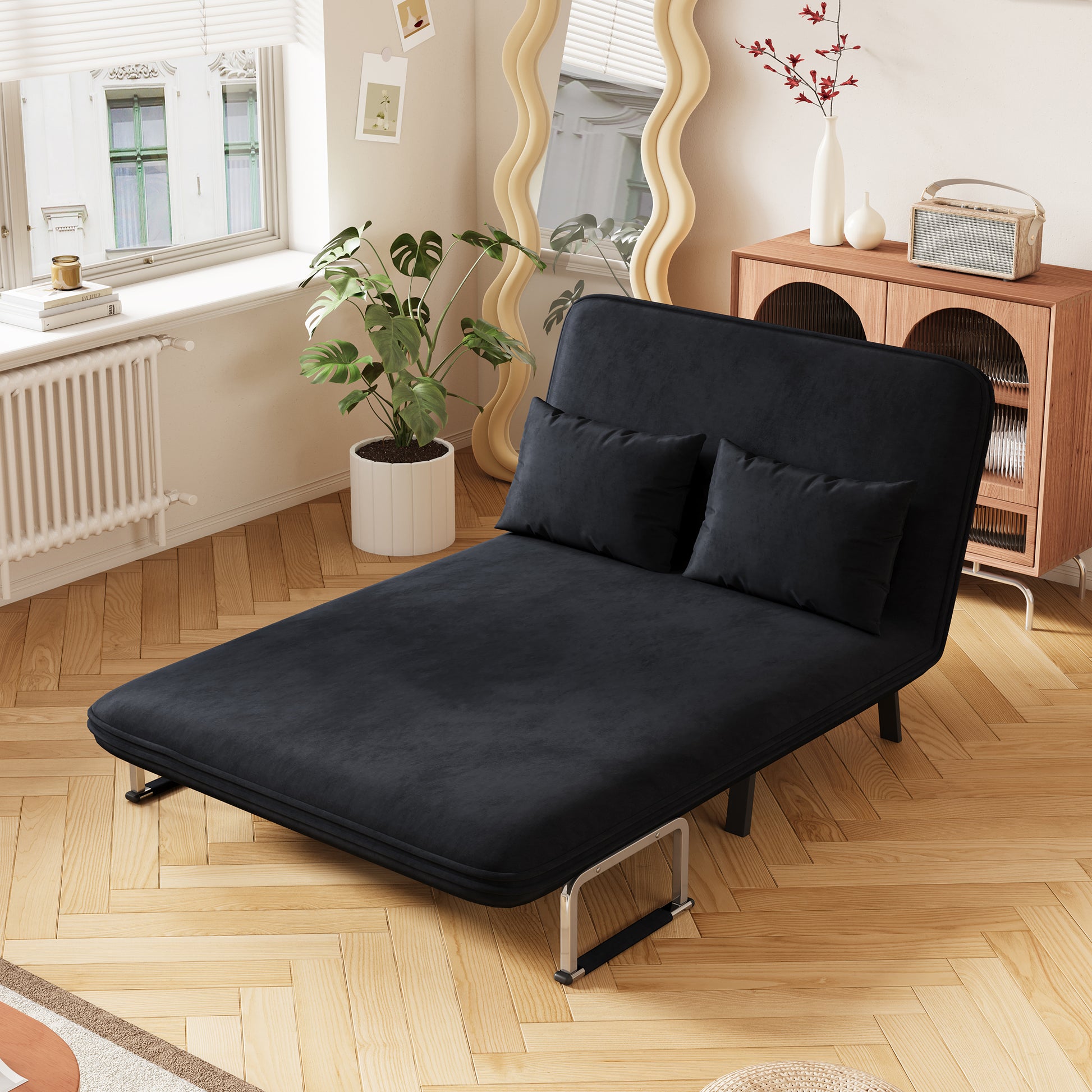 Black velvet sofa bed with plush cushions perfect for small living spaces and guest rooms