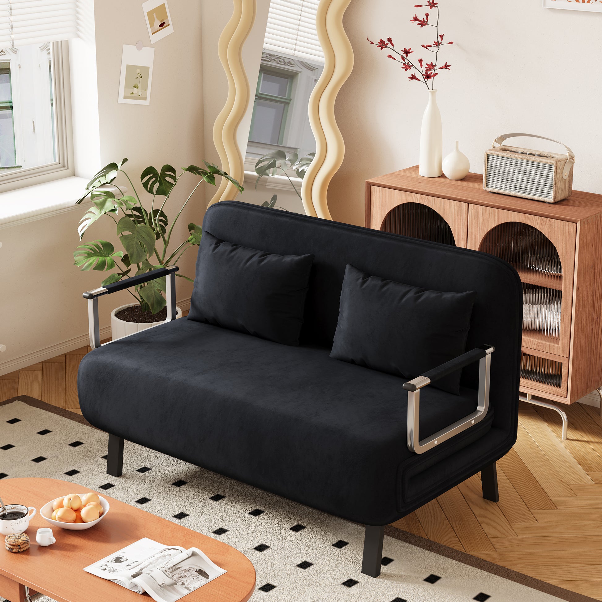 Sleek black velvet sofa with silver armrests perfect for small apartment living
