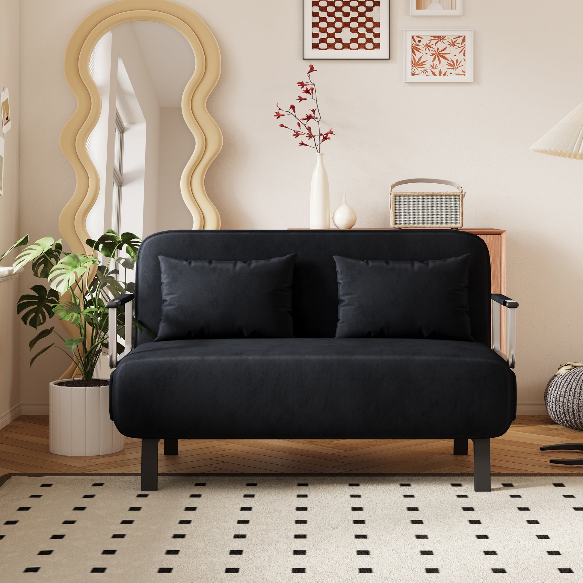 Black velvet loveseat with two accent pillows for small spaces