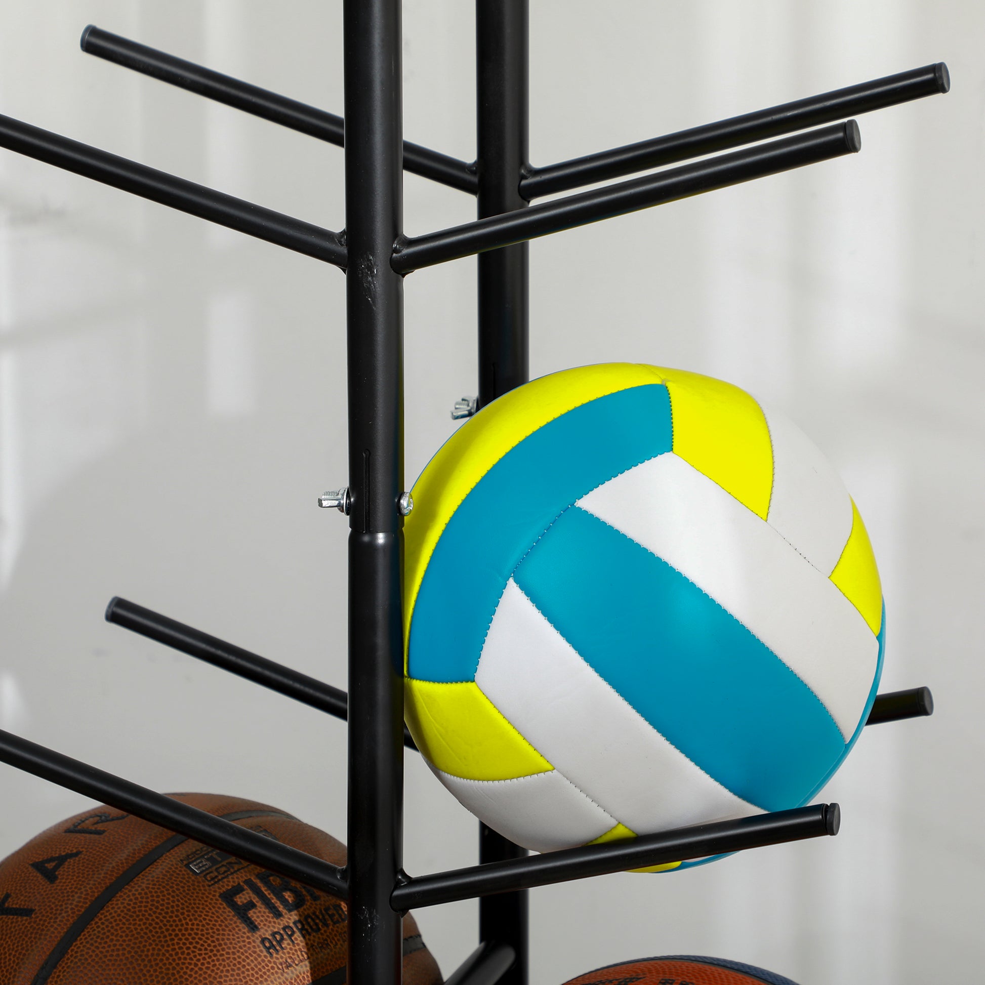 Bright yellow blue and white volleyball with stitched panels on a black stand