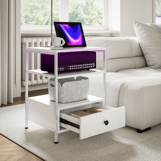 White metal end table with three shelves and one drawer holding a tablet and receiver