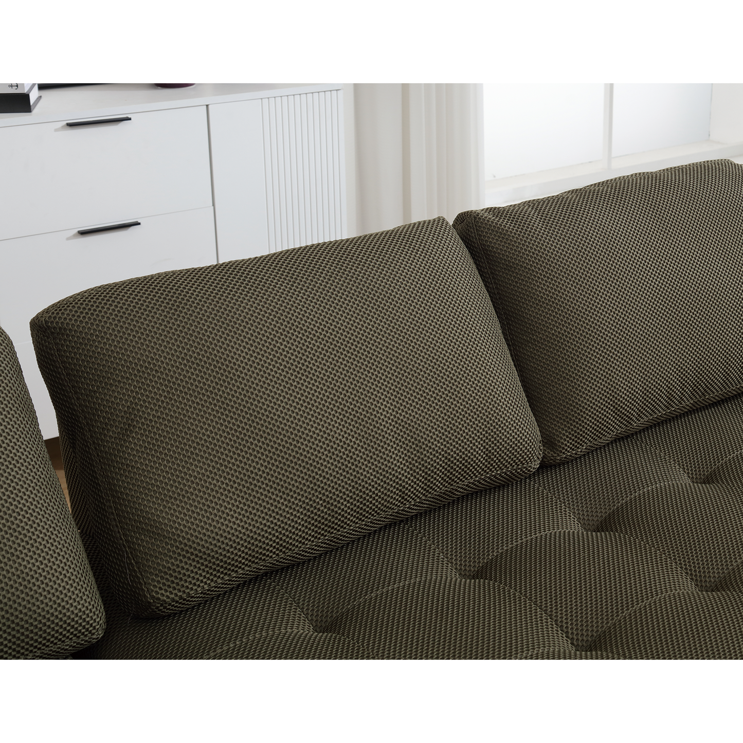 Closeup of plush textured olive green sofa cushions perfect for a modern living room