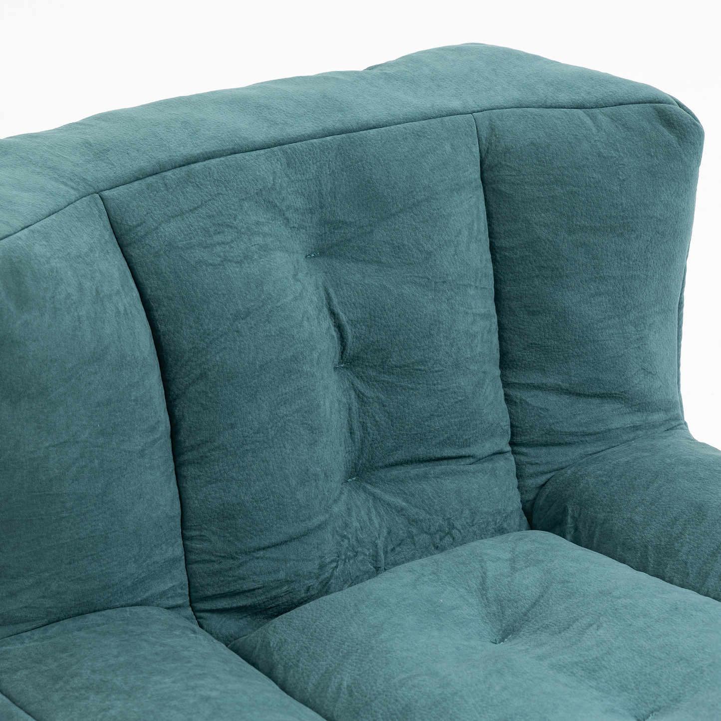 Teal upholstered sofa with tufted back cushions and deep seat