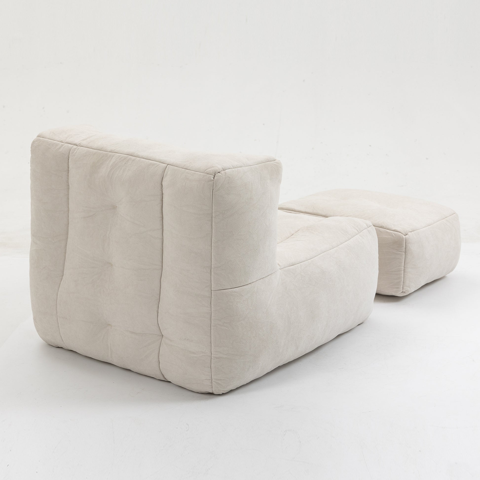 Tufted beige armchair with a matching ottoman featuring textured fabric upholstery for modern living rooms