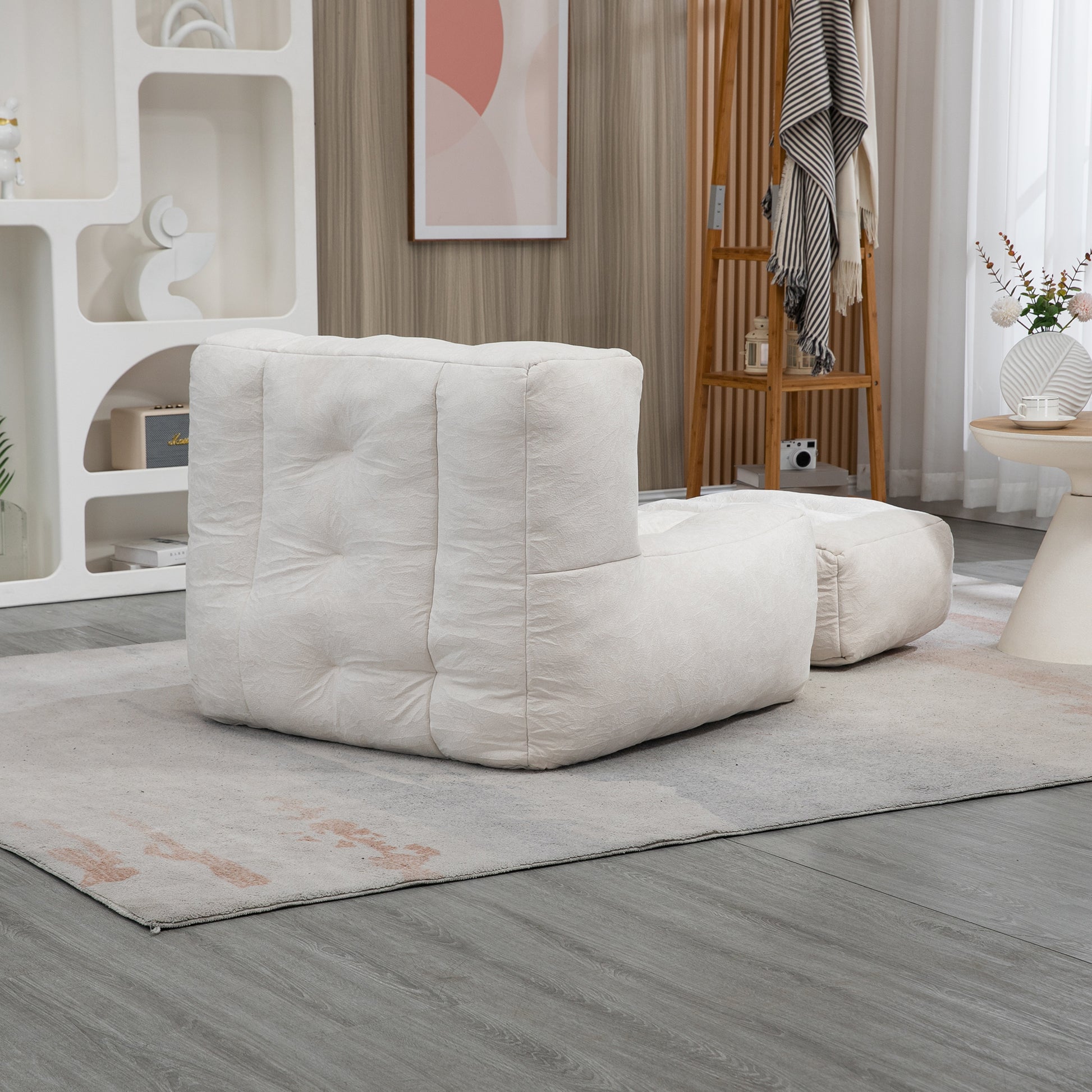 Cream textured modular sofa with ottoman on a rug