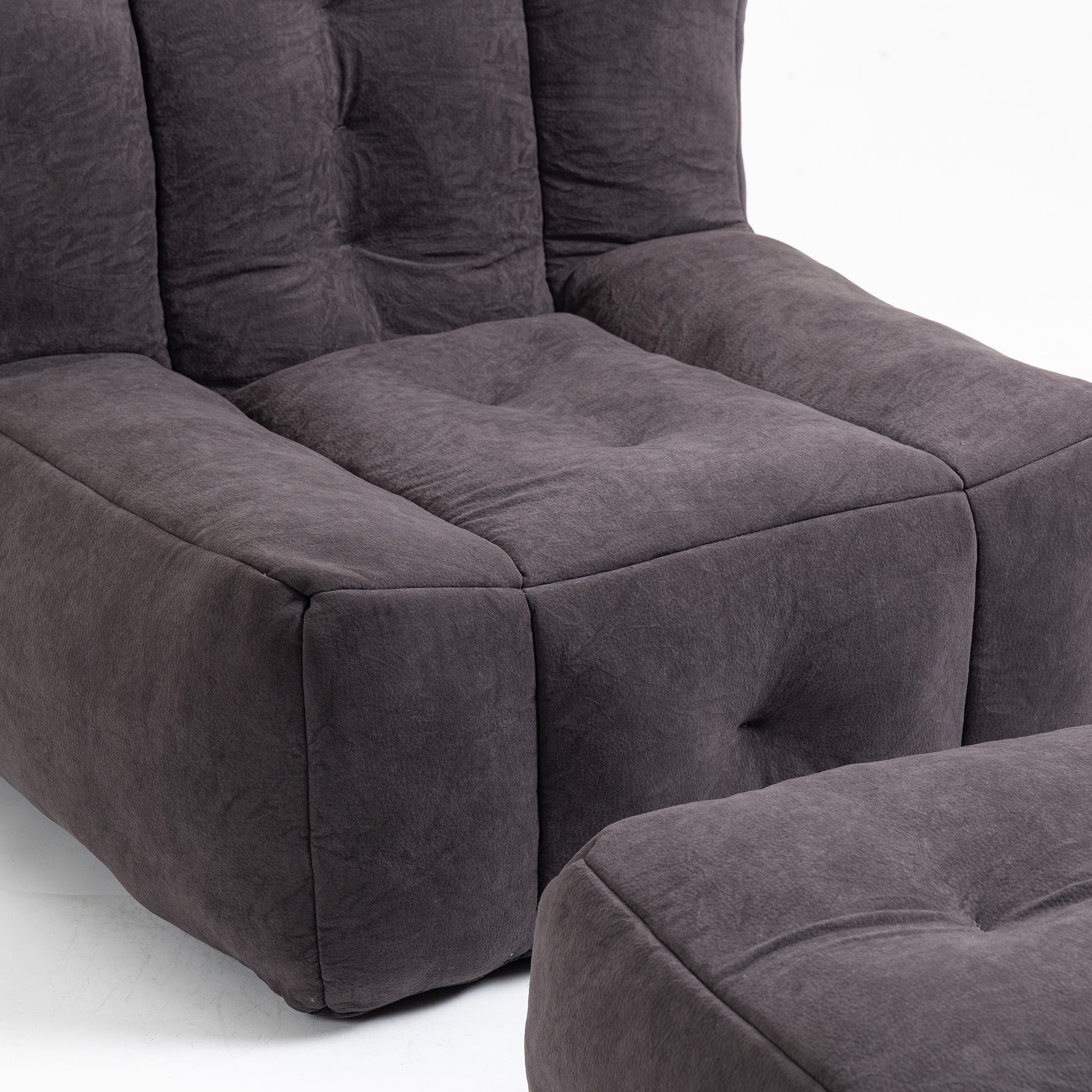 Dark grey tufted fabric armchair with matching ottoman modern modular design